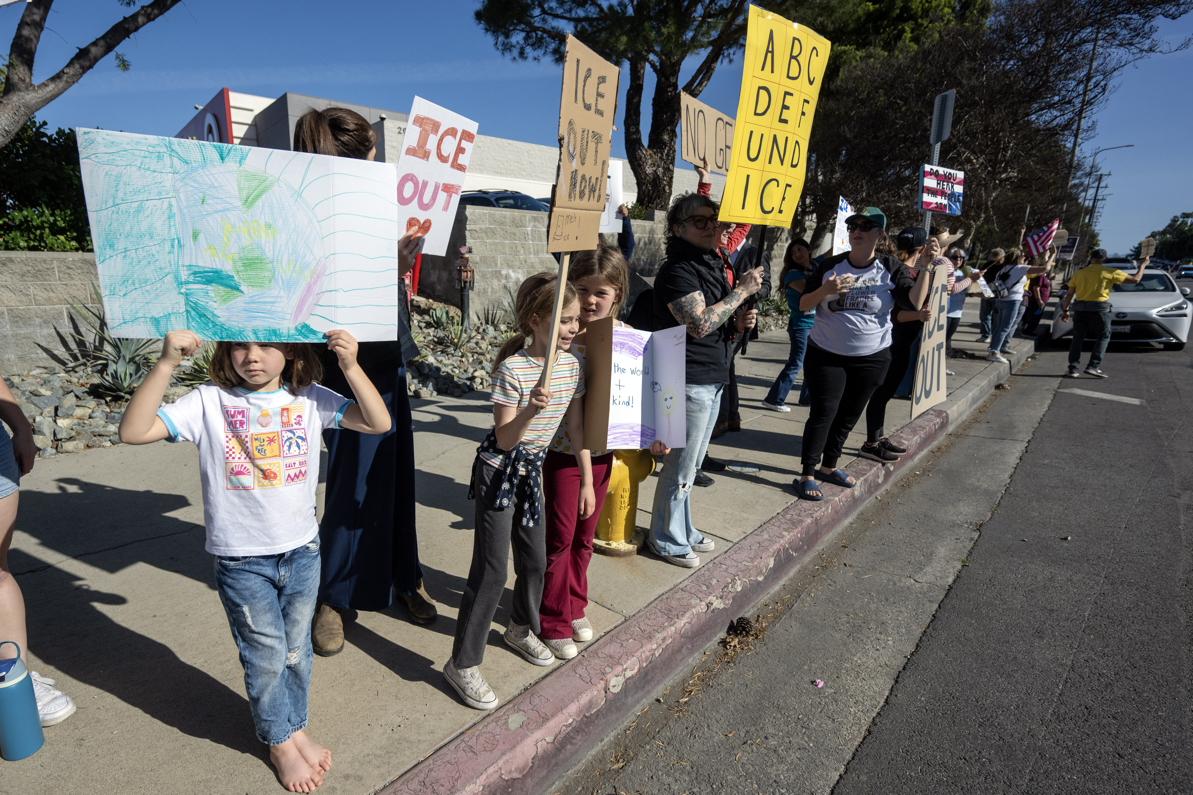 Protesters hold signs on Ventura Blvd near a Target store...