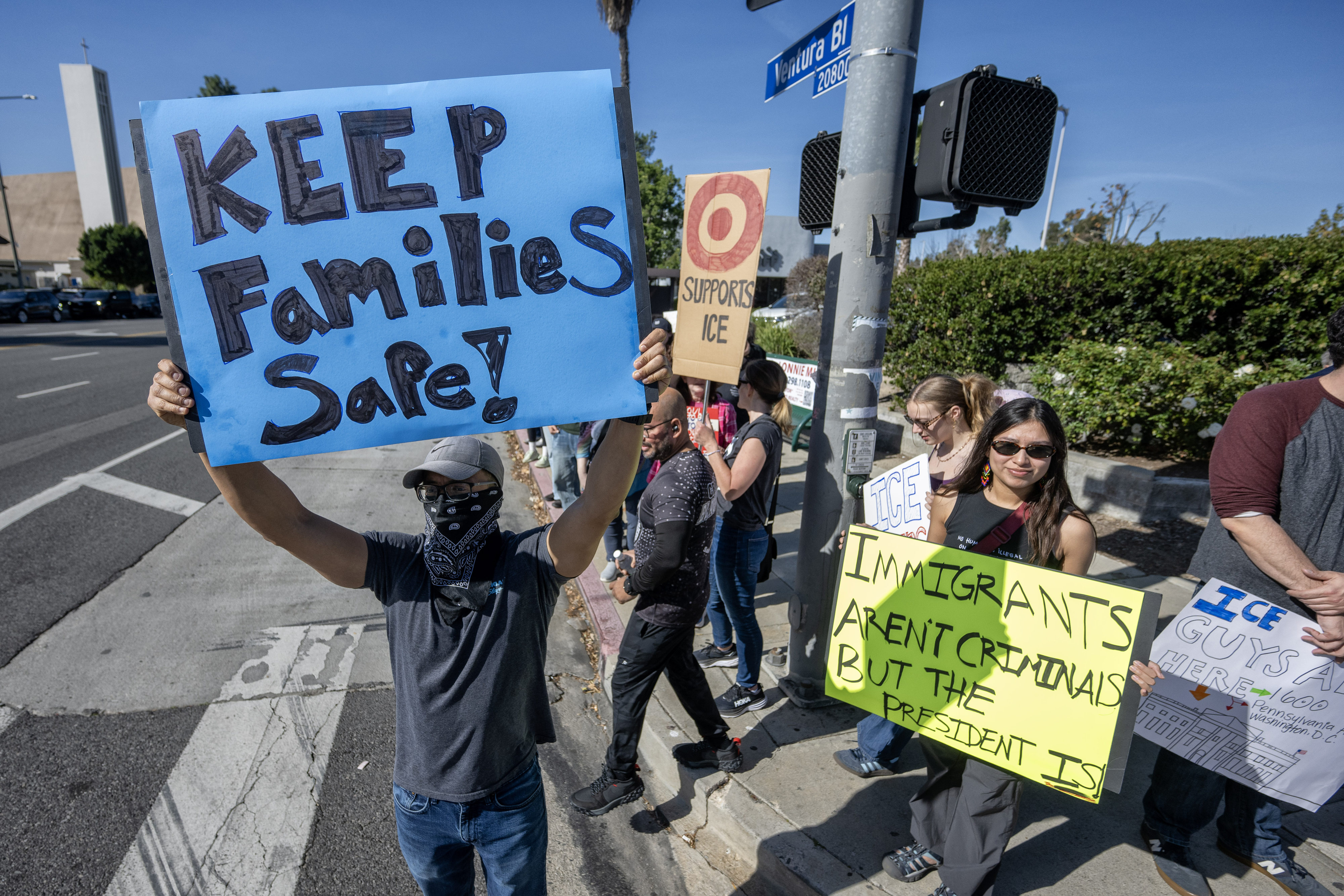 Protesters hold signs on Ventura Blvd near a Target store...