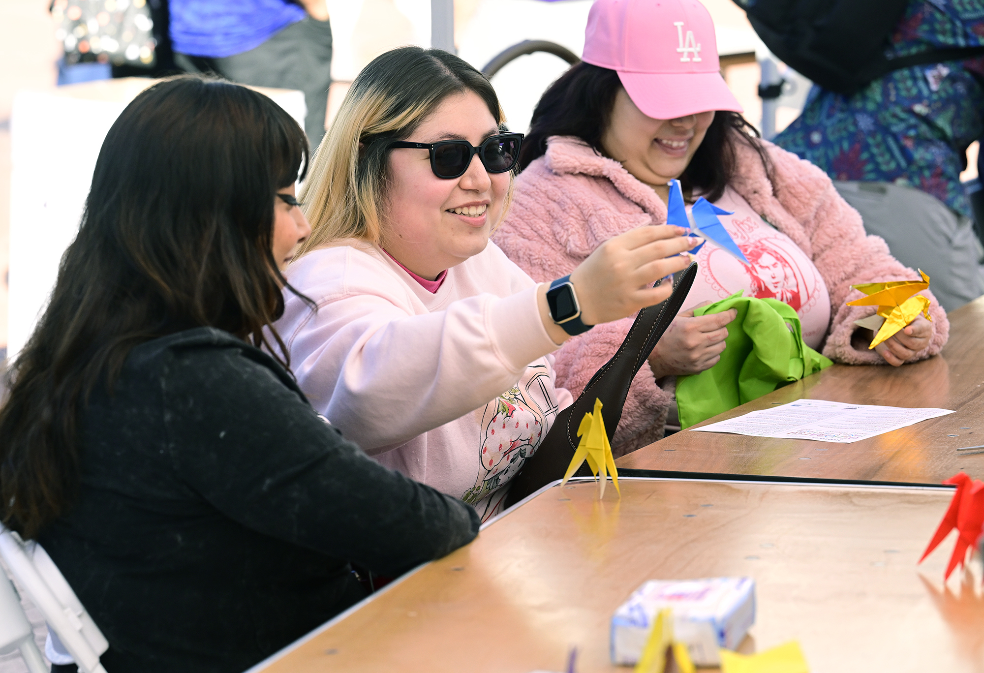 (L-r) Hannah Garduno, Kendra Campos and Diana Figueroa make paper...