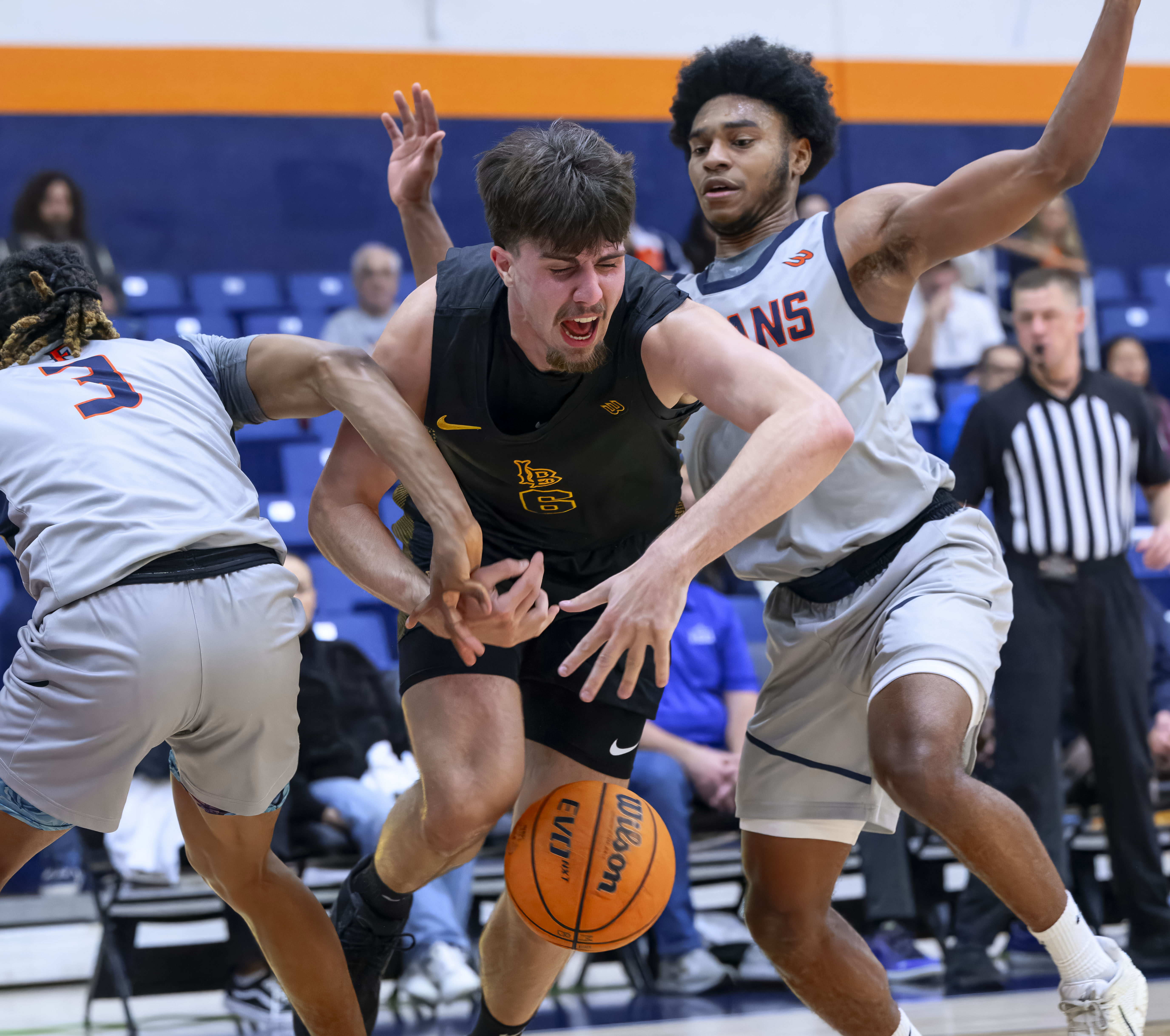 Long Beach State forward Petar Majstorovic, center, loses control of...