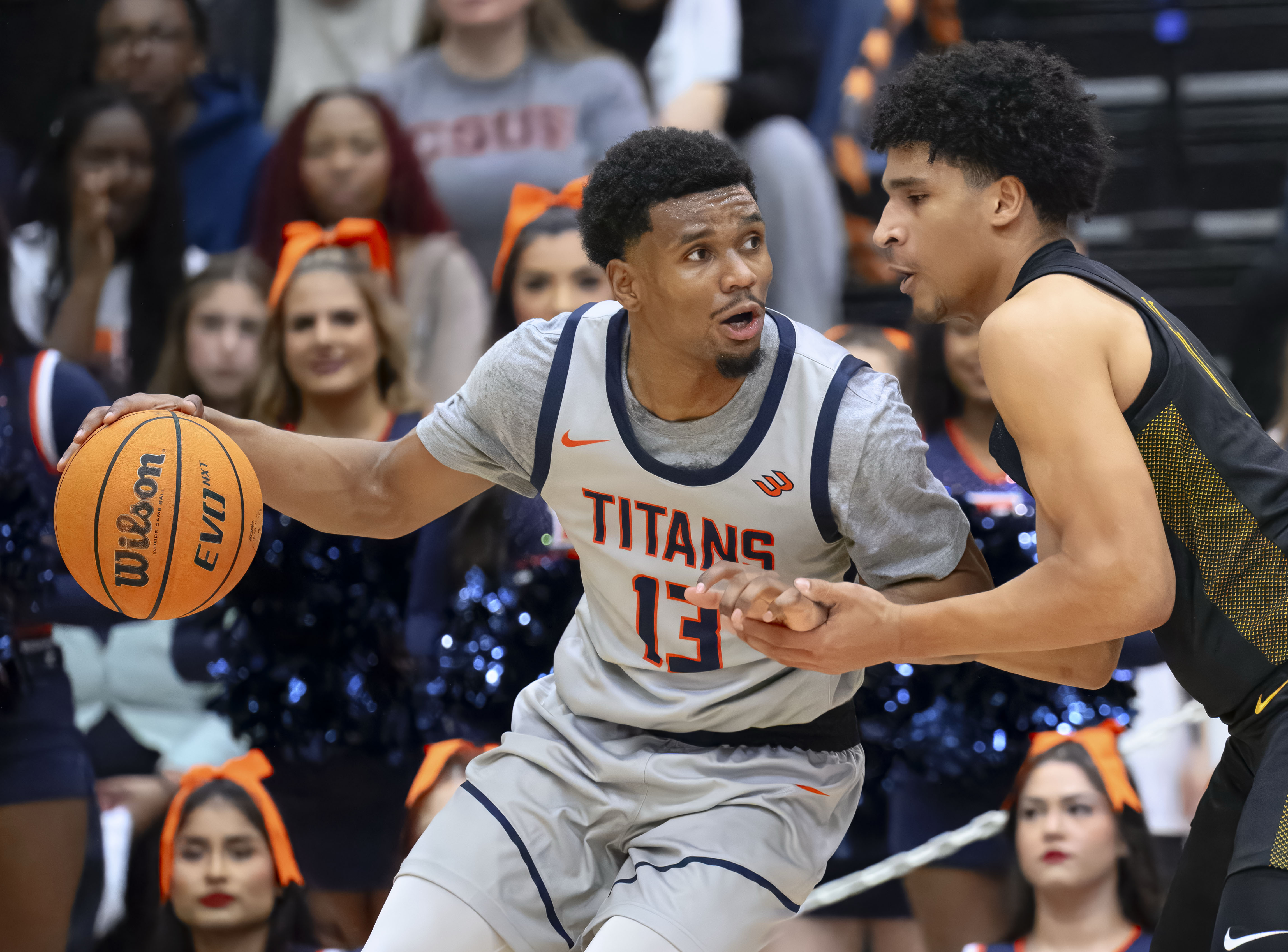 Cal State Fullerton guard Jefferson De La Cruz Monegro, left,...