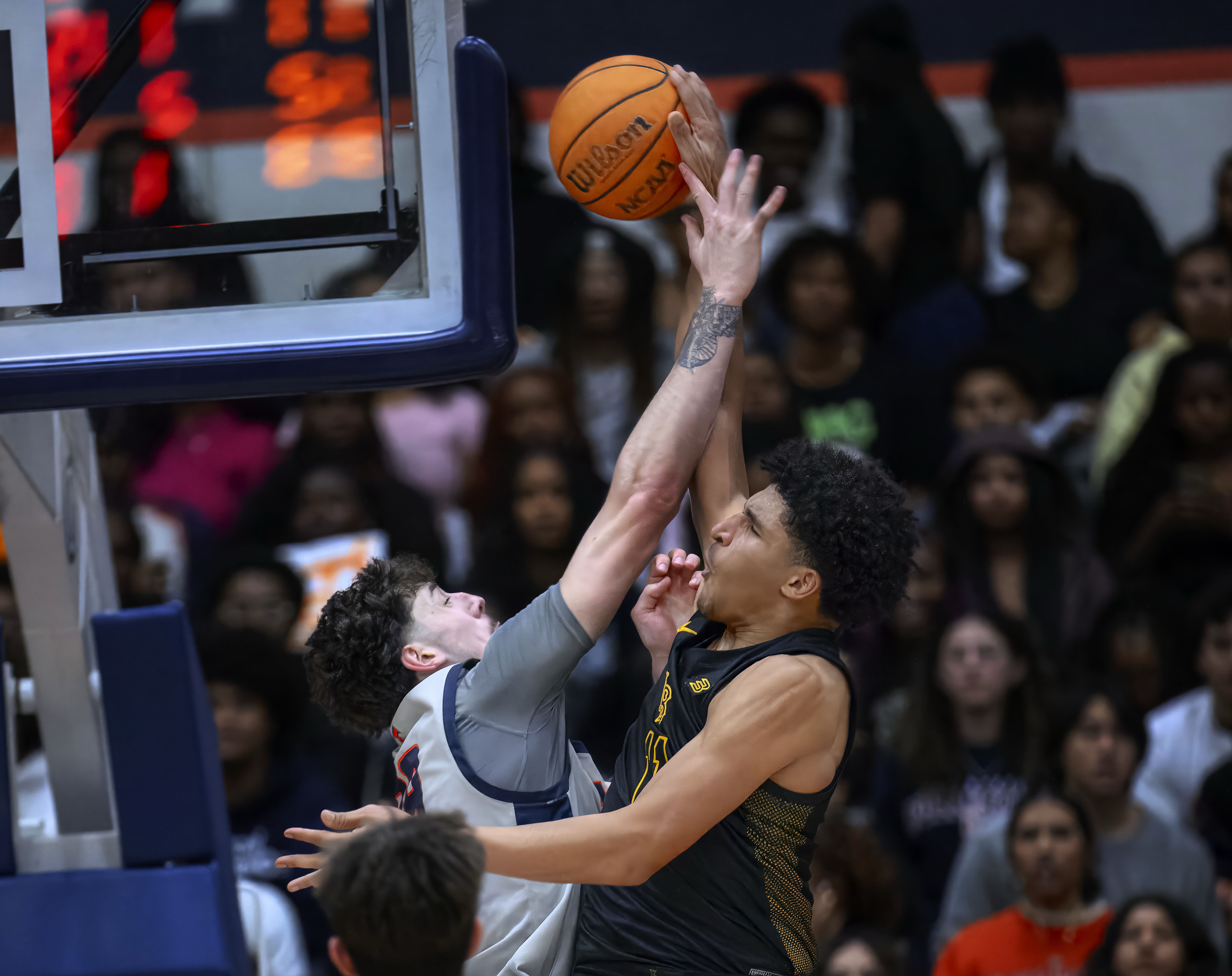 Cal State Fullerton forward Landon Seaman, left, blocks a shot...