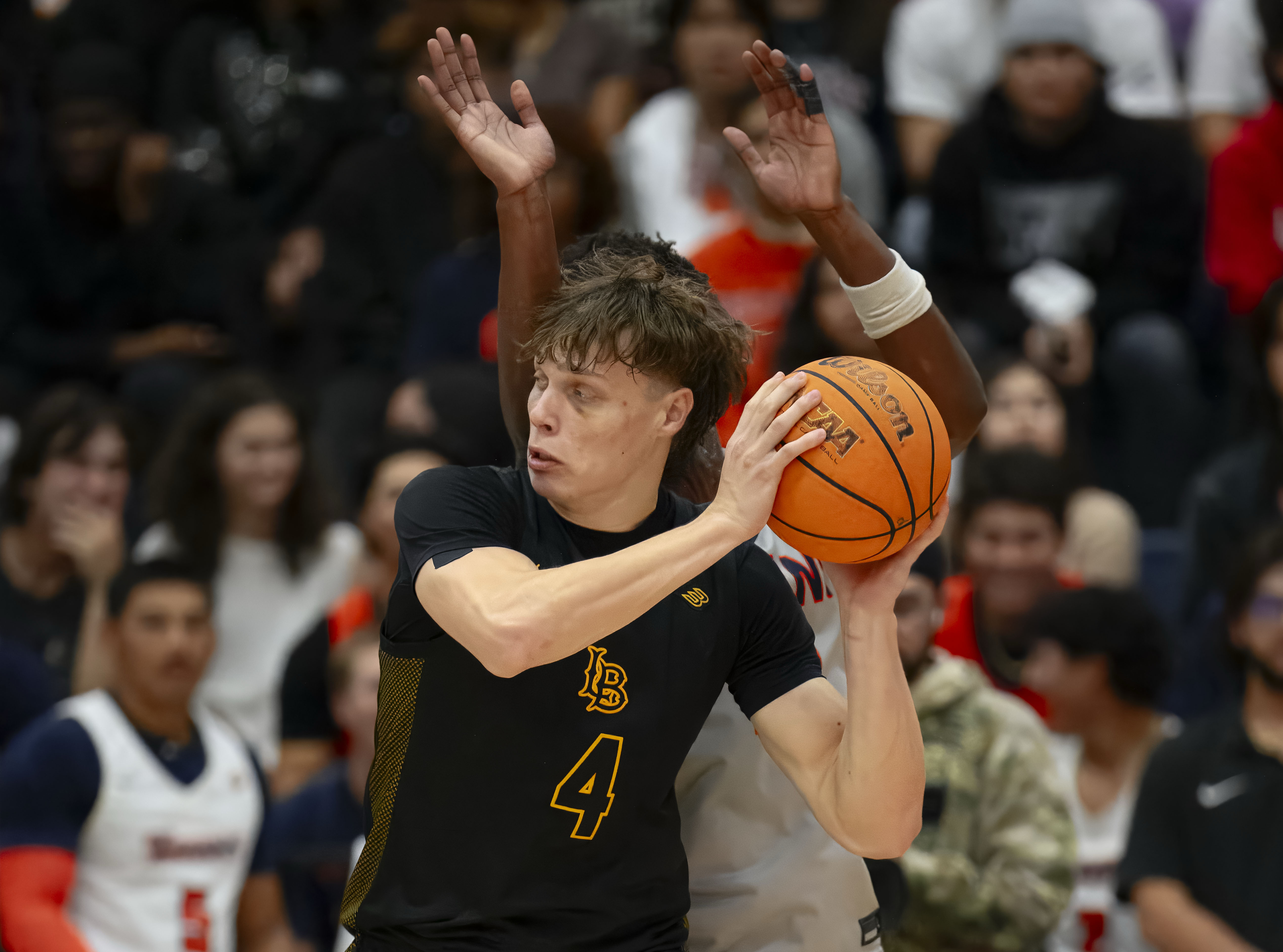 Long Beach State forward Leopold Levillain looks to pass the...