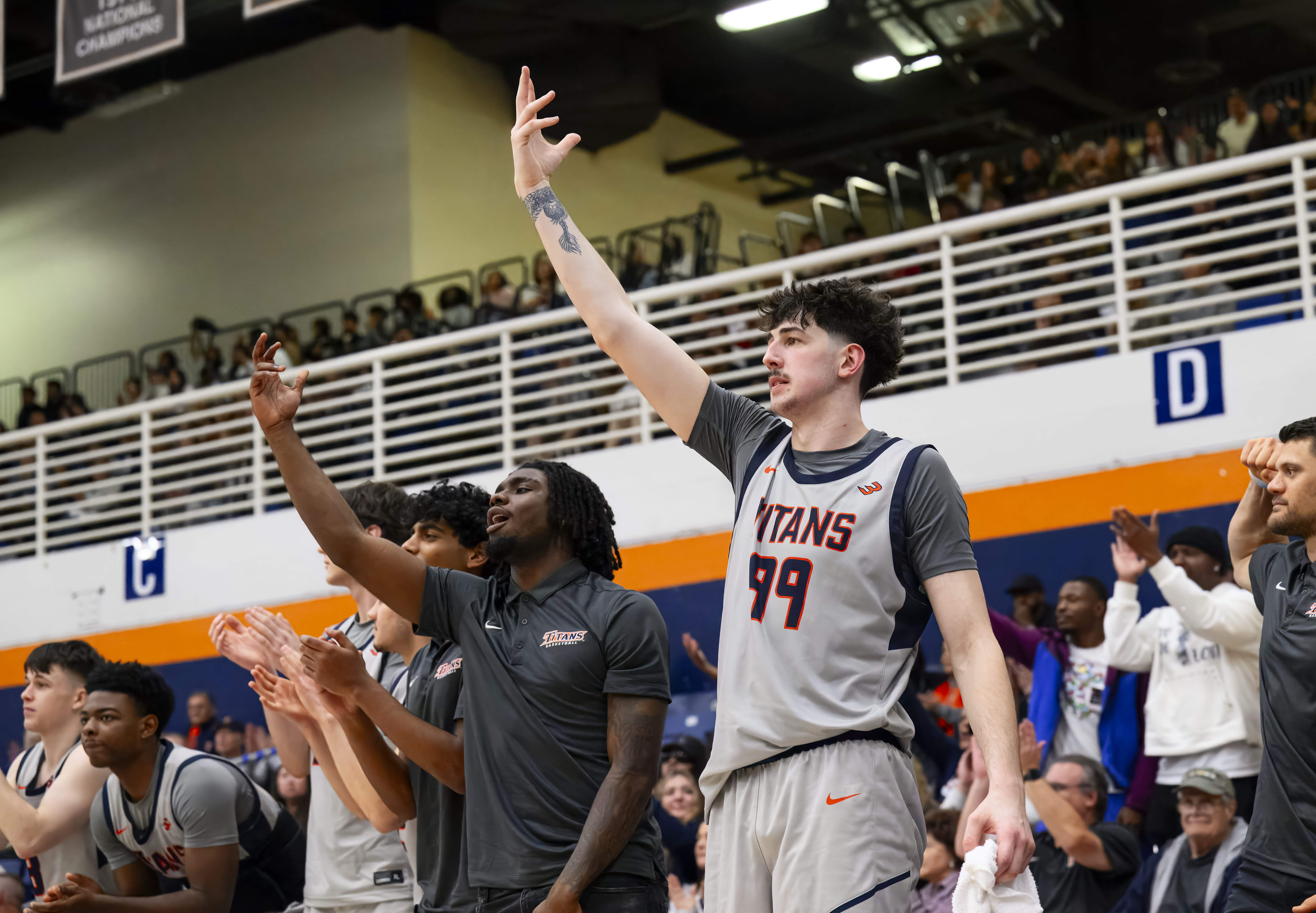Cal State Fullerton forward Landon Seaman, right, cheers his teammates...