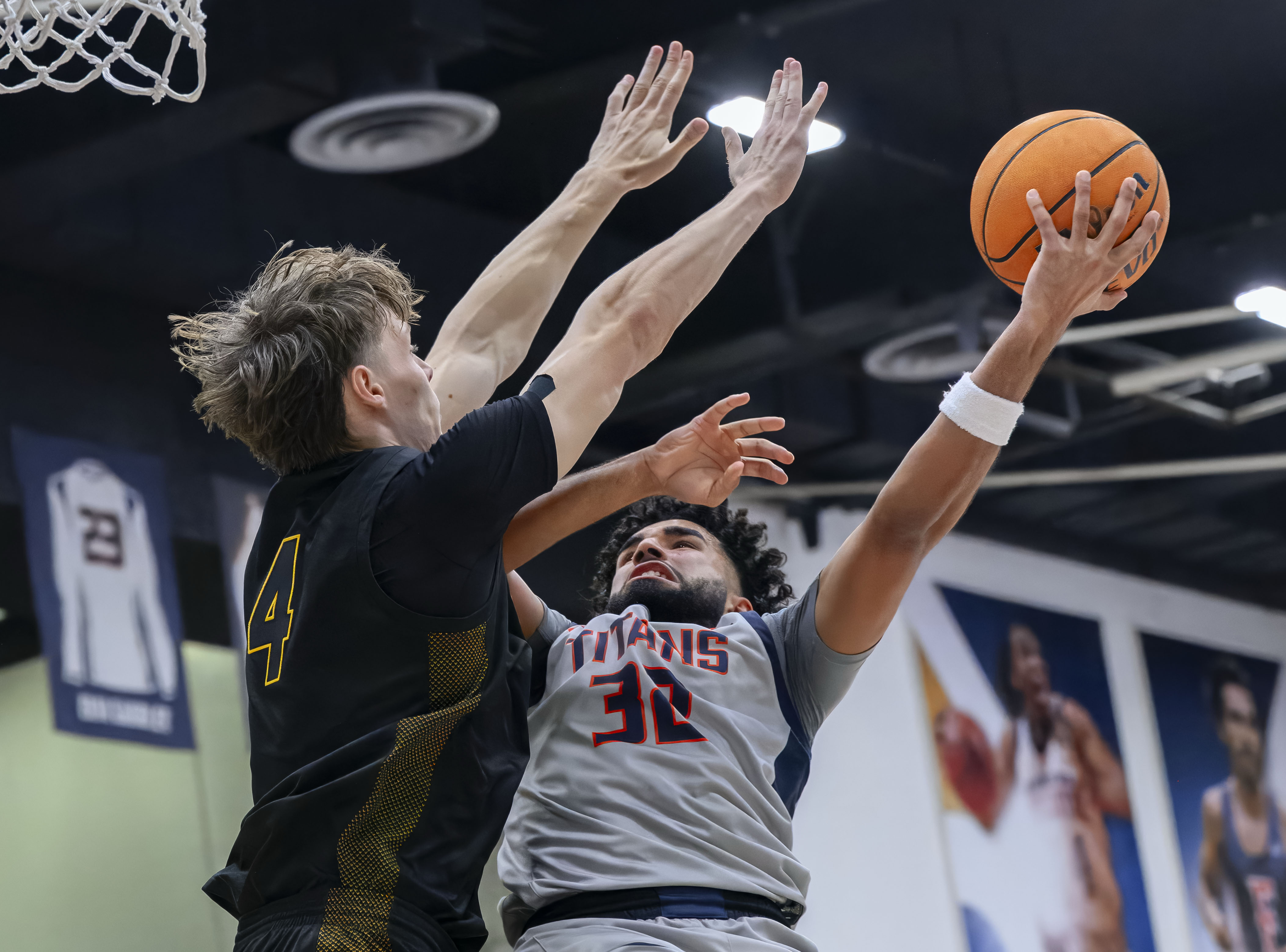 Long Beach State forward Leopold Levillain, left, gets in front...