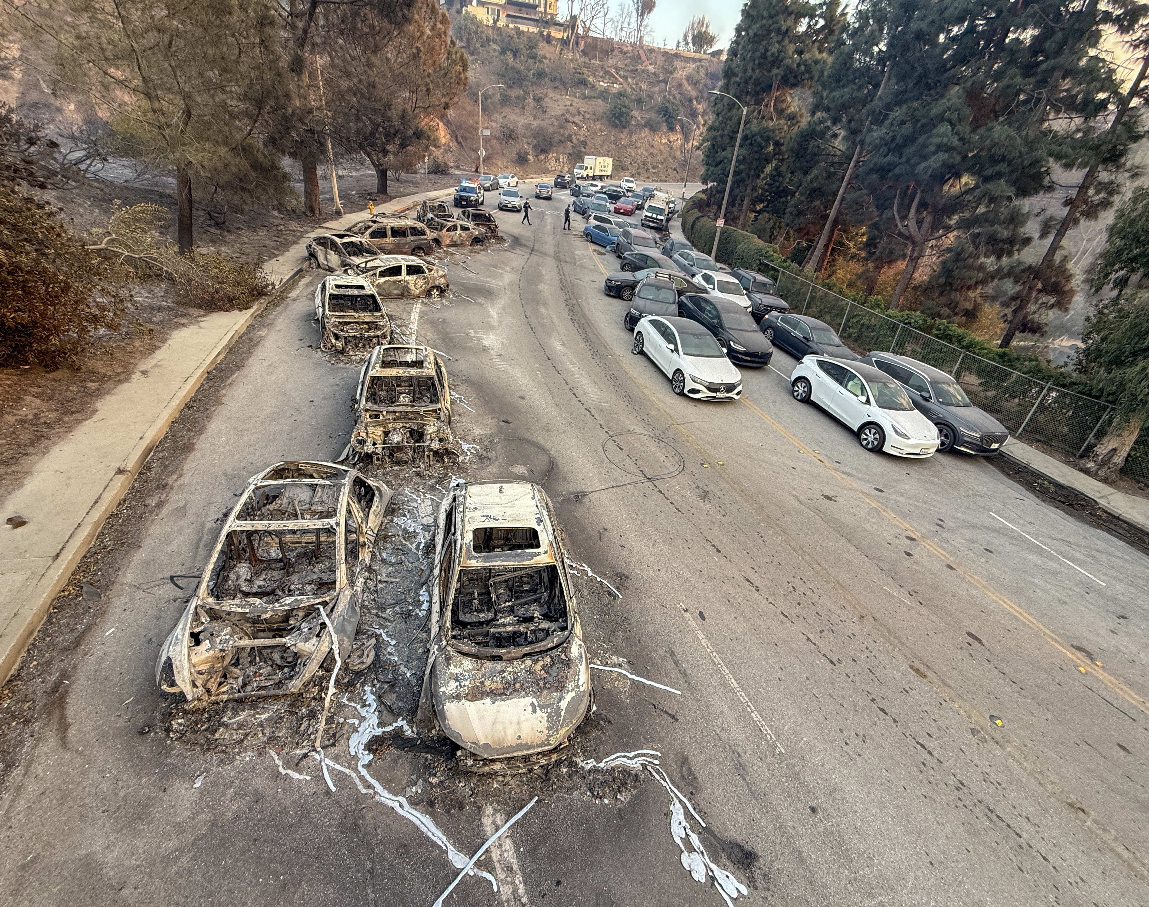 Abandoned cars sit on Sunset Boulevard during the Palisades fire...