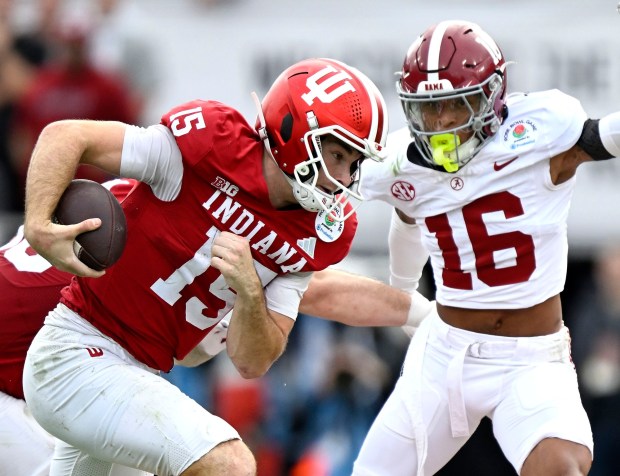 Indiana quarterback Fernando Mendoza (15) looks for running room as Alabama's Red Morgan (16) defends during the first half at the Rose Bowl in Pasadena on Thursday, Jan. 1, 2026. The top ranked Indiana Hoosiers play the 9th ranked Alabama Crimson Tide in the 112th Rose Bowl Game. (Photo by Will Lester, Inland Valley Daily Bulletin/SCNG)