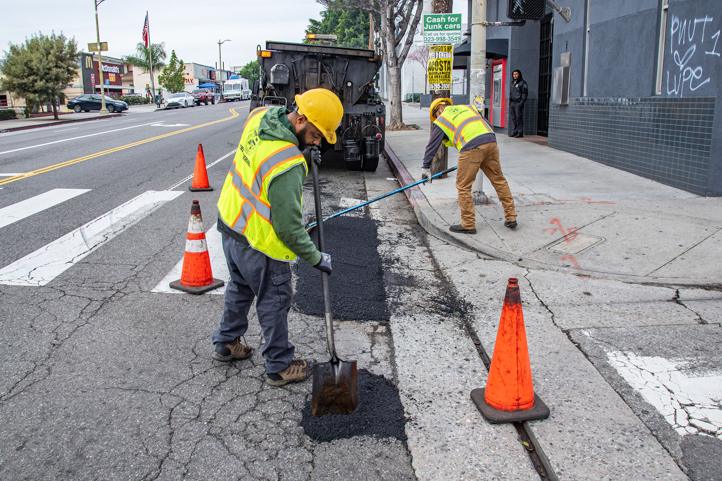 LA city workers repair potholes after a series of rainstorms...
