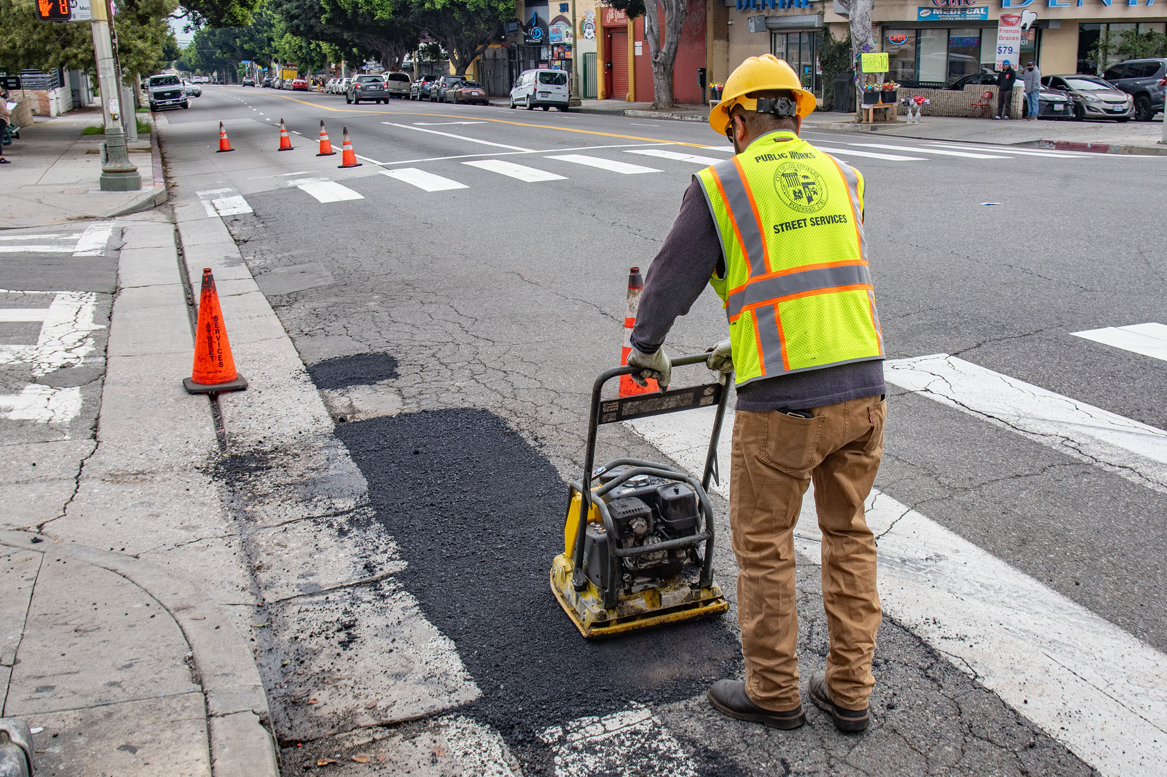 LA city workers repair potholes after a series of rainstorms...