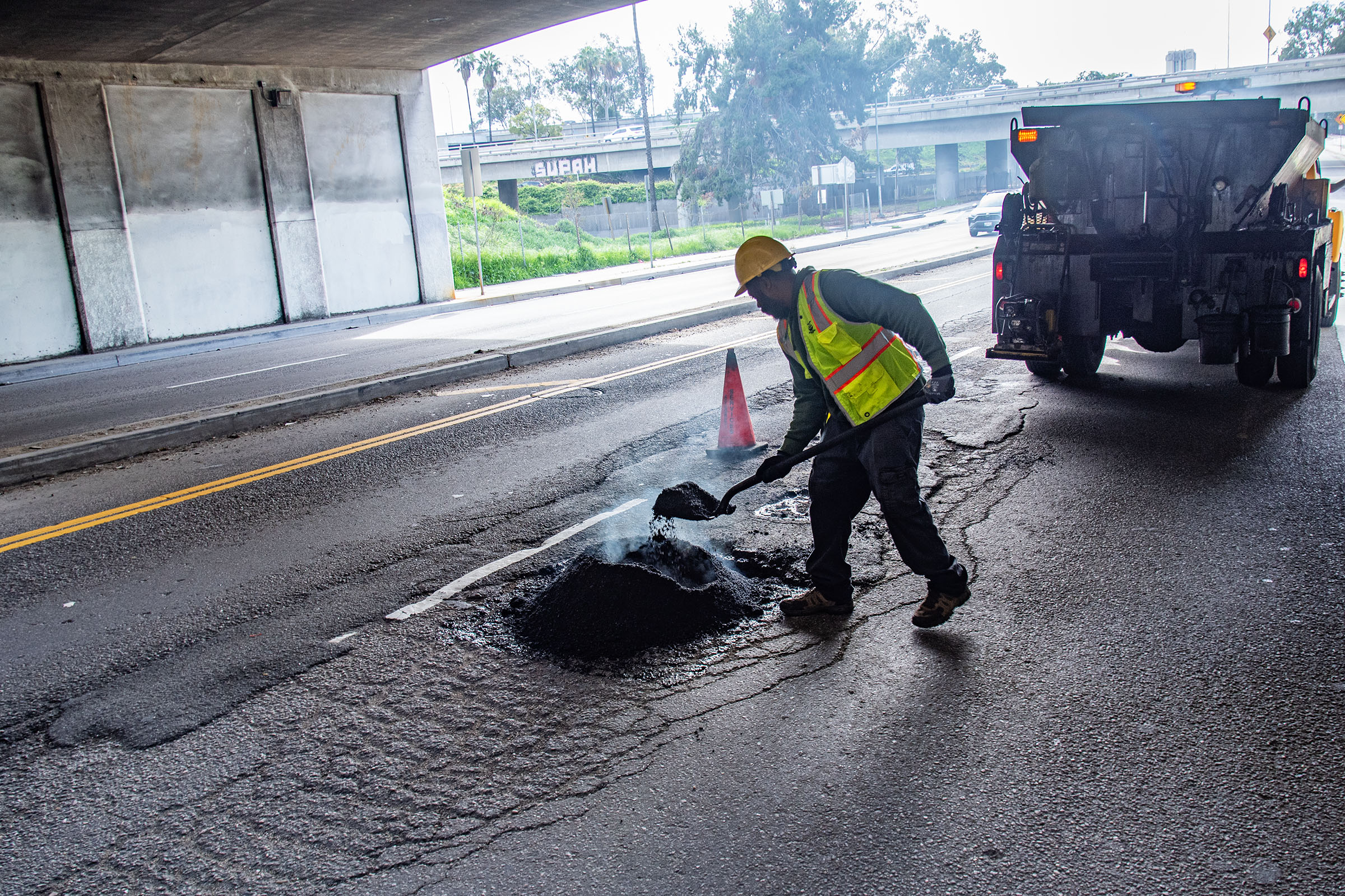 LA city workers repair potholes after a series of rainstorms...