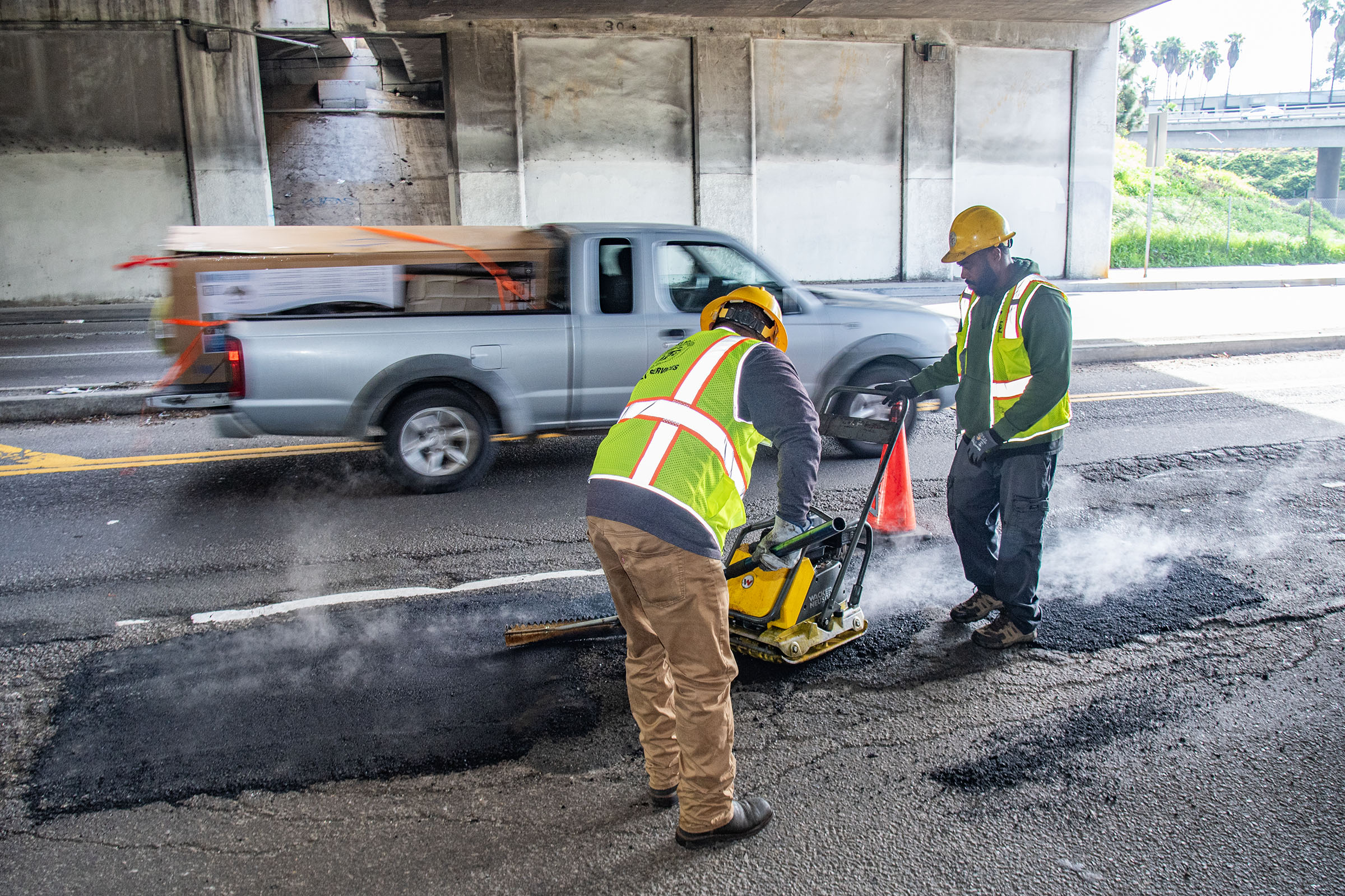 LA city workers repair potholes after a series of rainstorms...