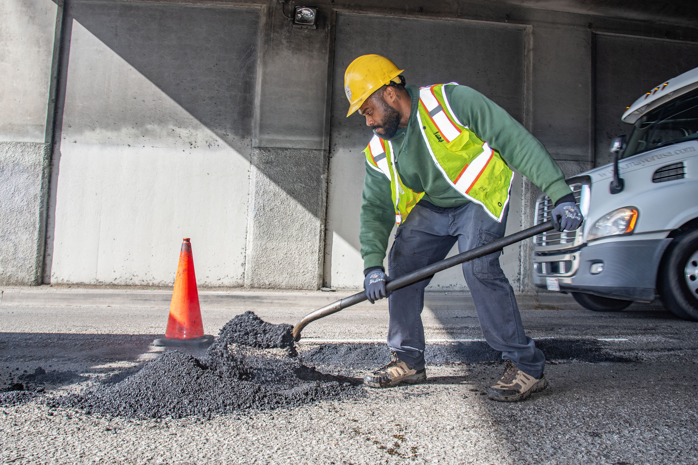 LA city workers repair potholes after a series of rainstorms...