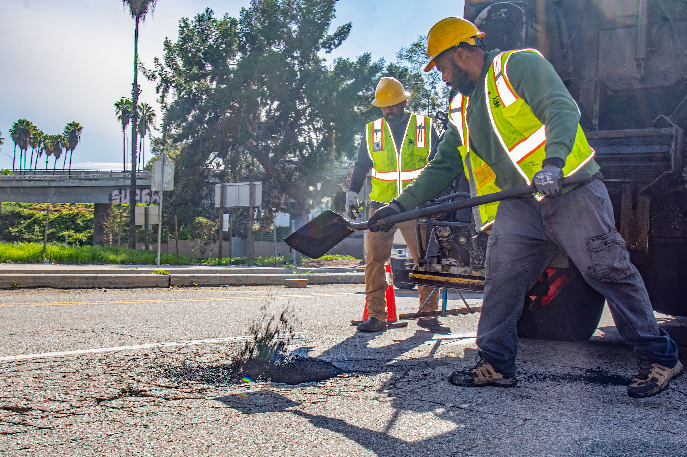 LA city workers repair potholes after a series of rainstorms...