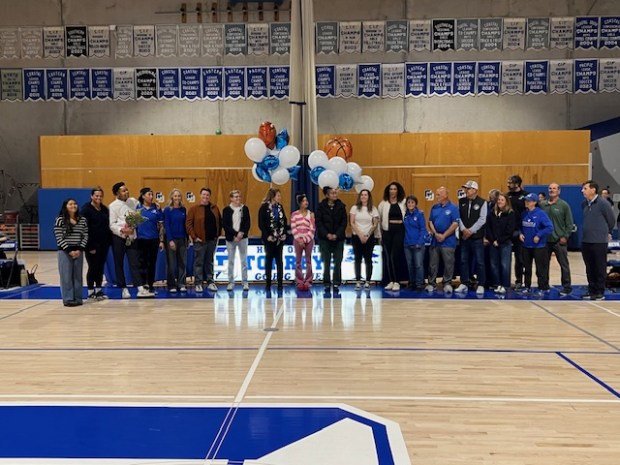 Former players join faculty members and others at a dedication ceremony for Terri Bamford Court before La Jolla Country Day School's girls basketball game against Torrey Pines High School. (Provided by Jeff Hutzler)