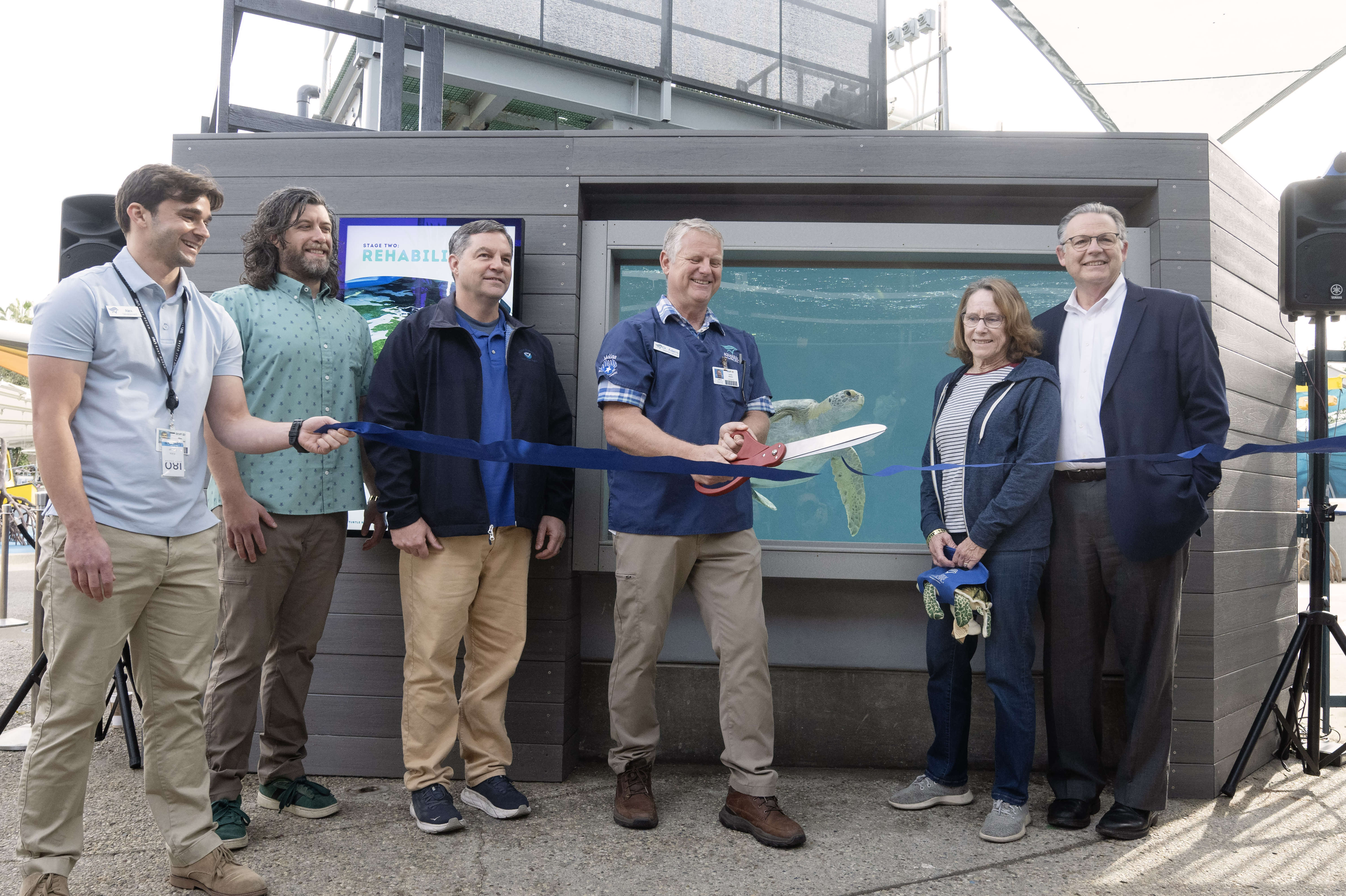 Veterinarian Dr. Lance Adams, center, celebrates the grand opening of...