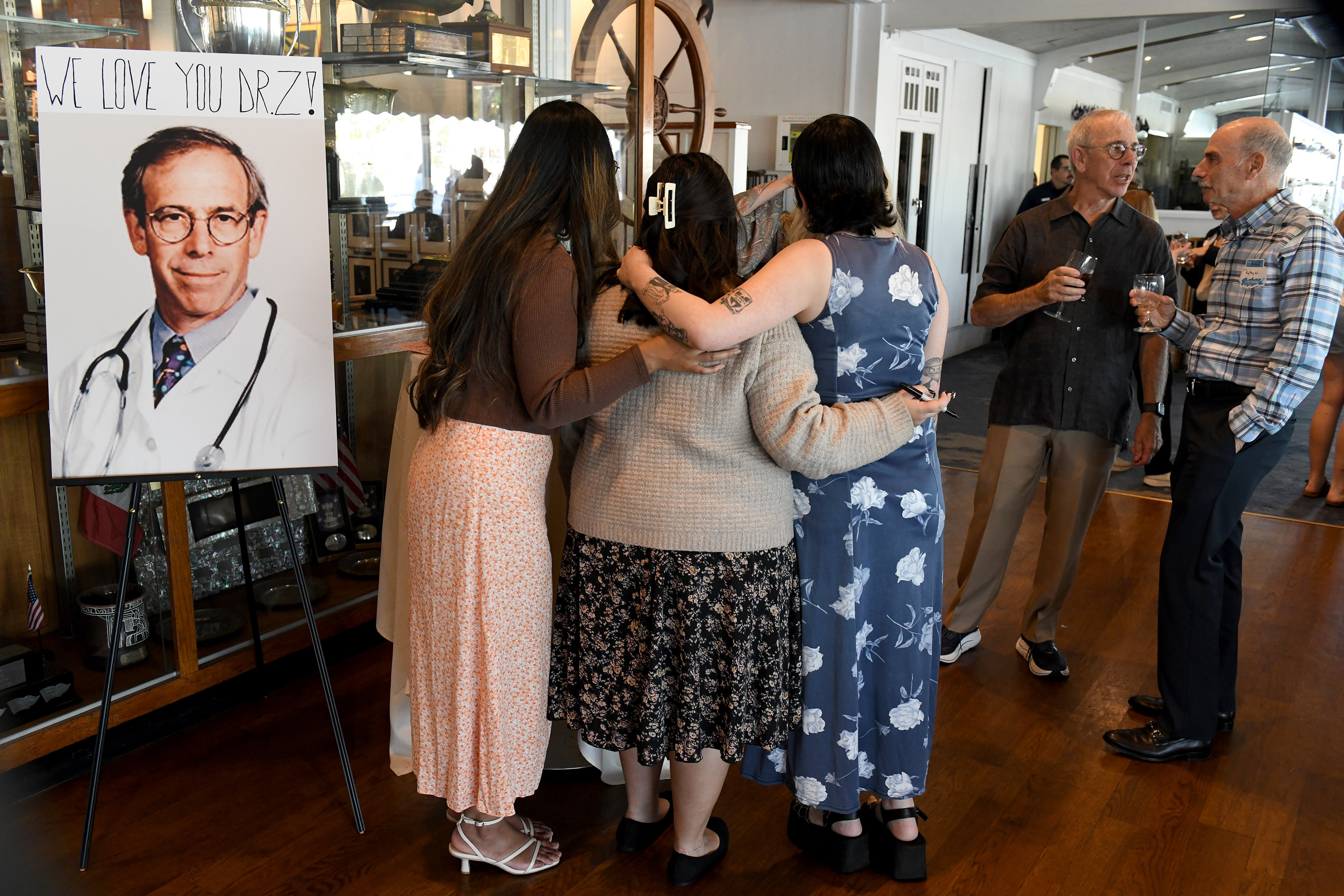 Family, friends and patients attend a farewell reception for Dr....