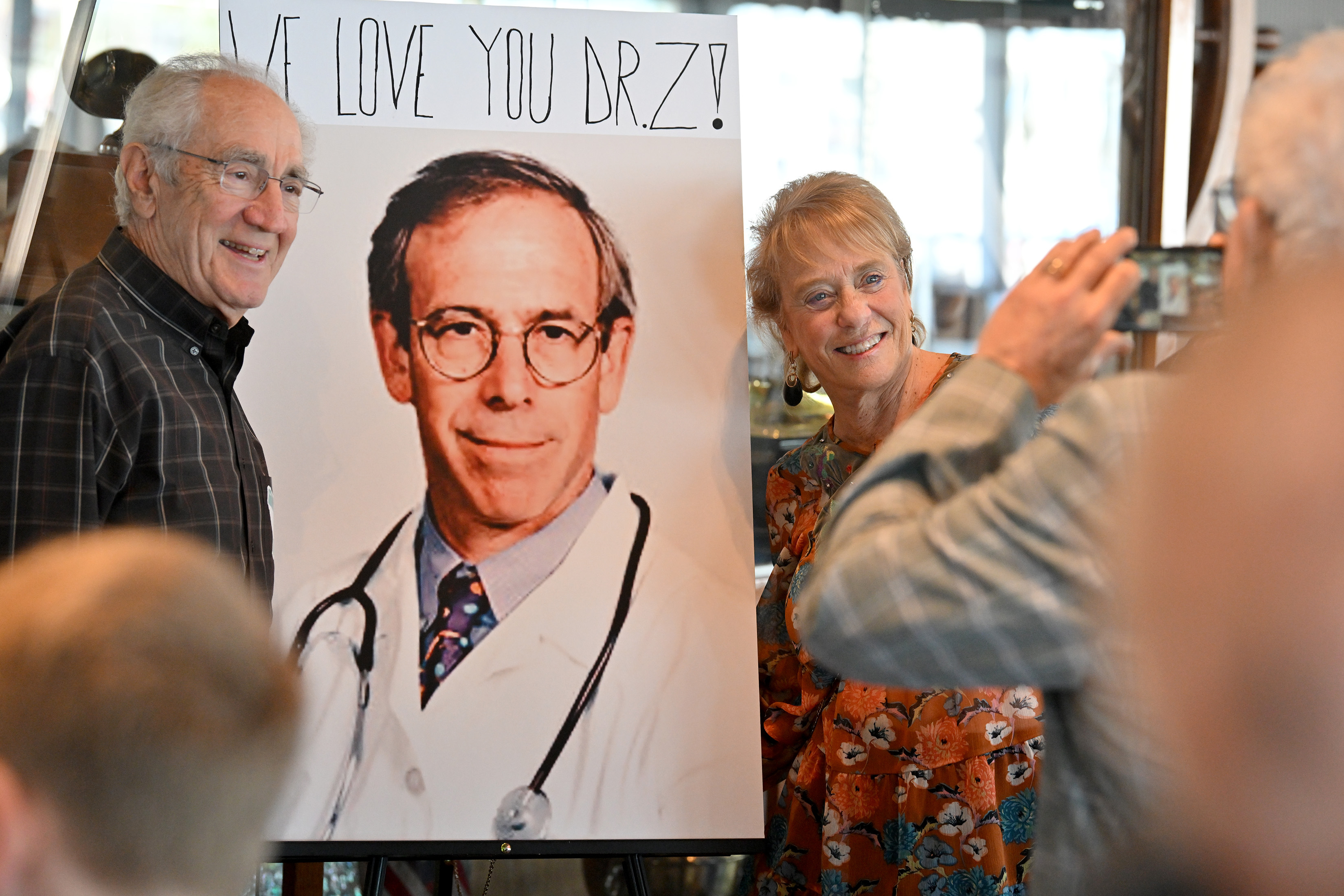 Family, friends and patients attend a farewell reception for Dr....