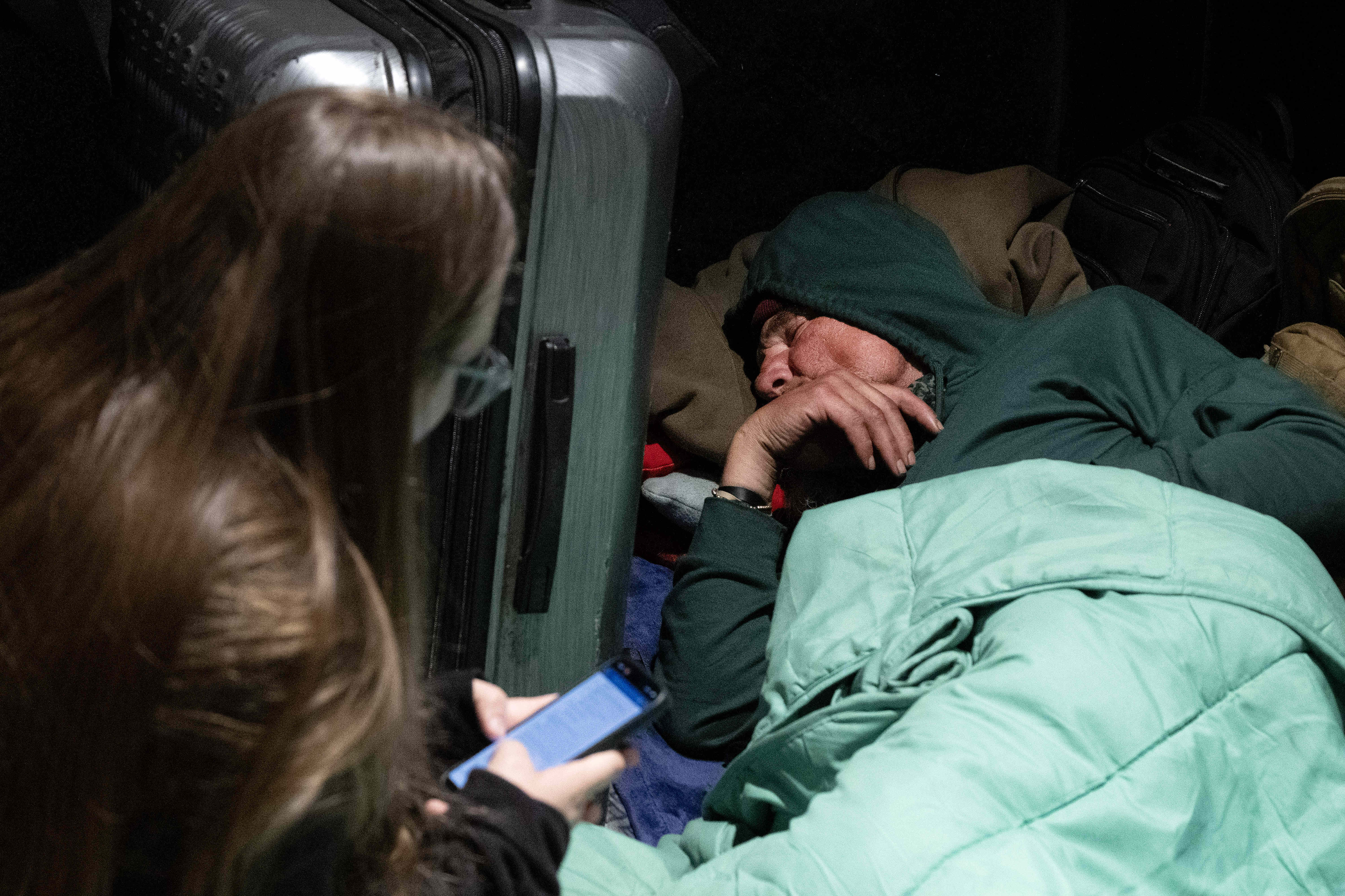 Volunteer Sophia Perry, left, interviews a person experiencing homelessness during...