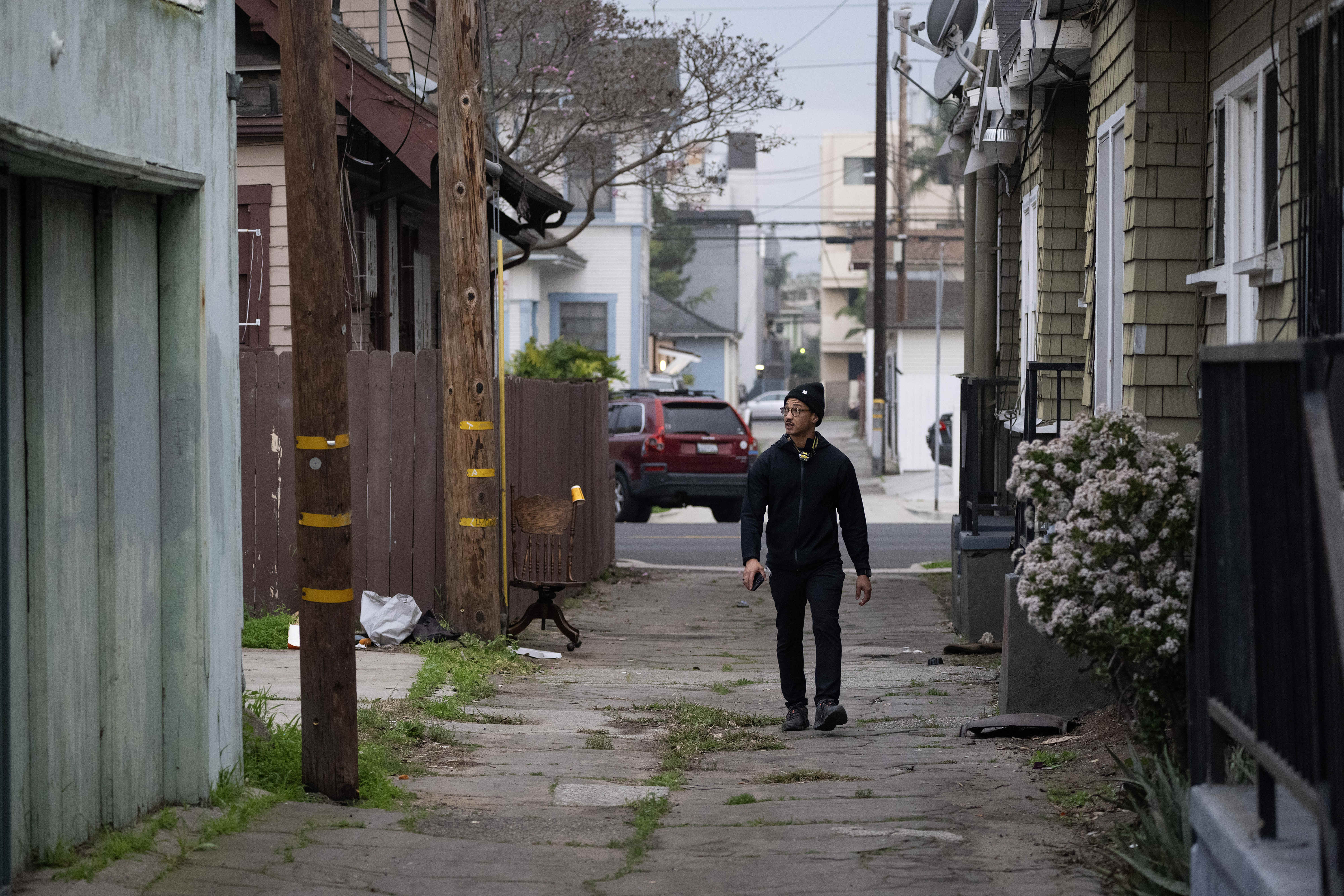 Volunteer Austin Metoyer checks an alley for people experiencing homelessness...