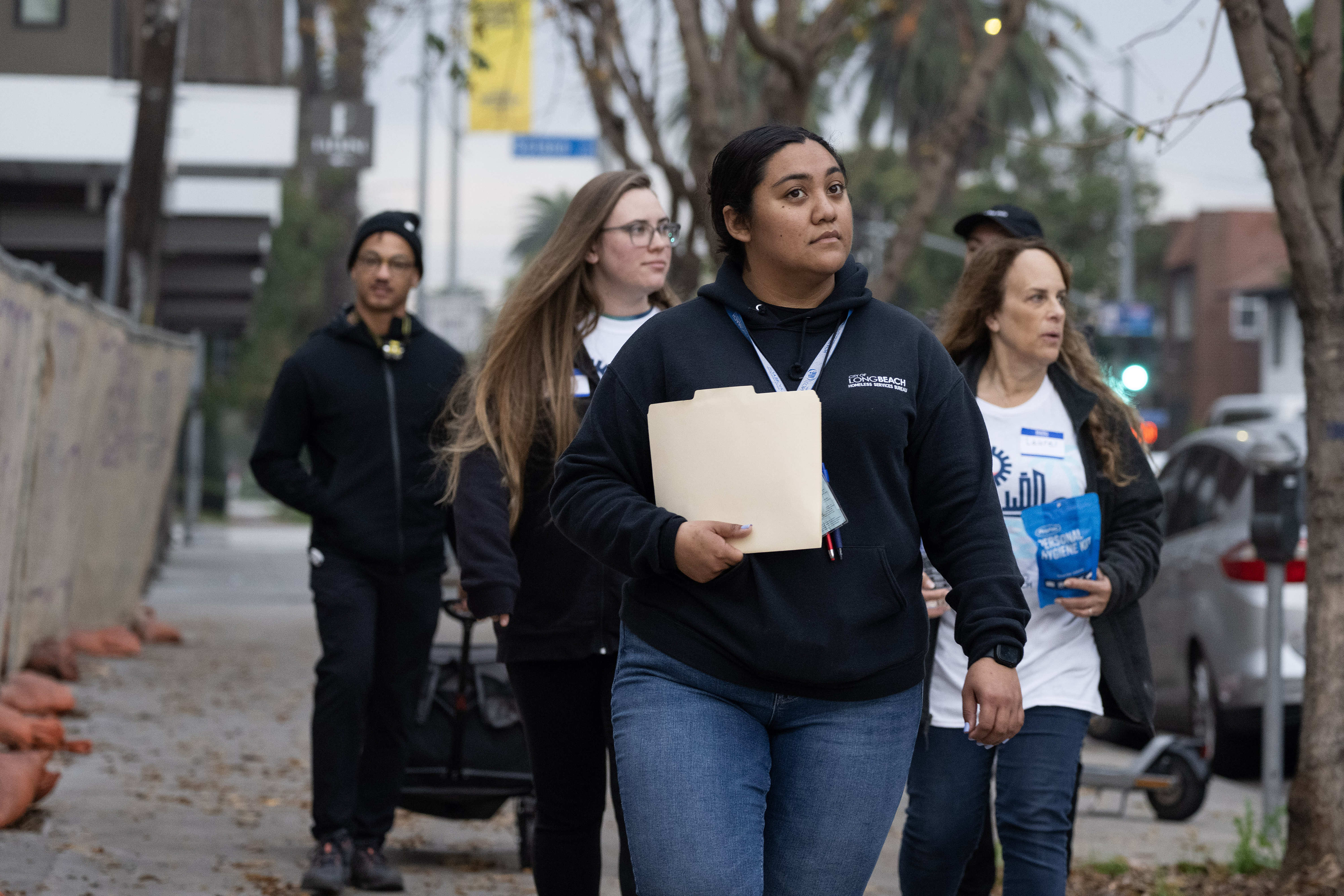 Katelyn Jaramillo, center, leads a group of volunteers during the...
