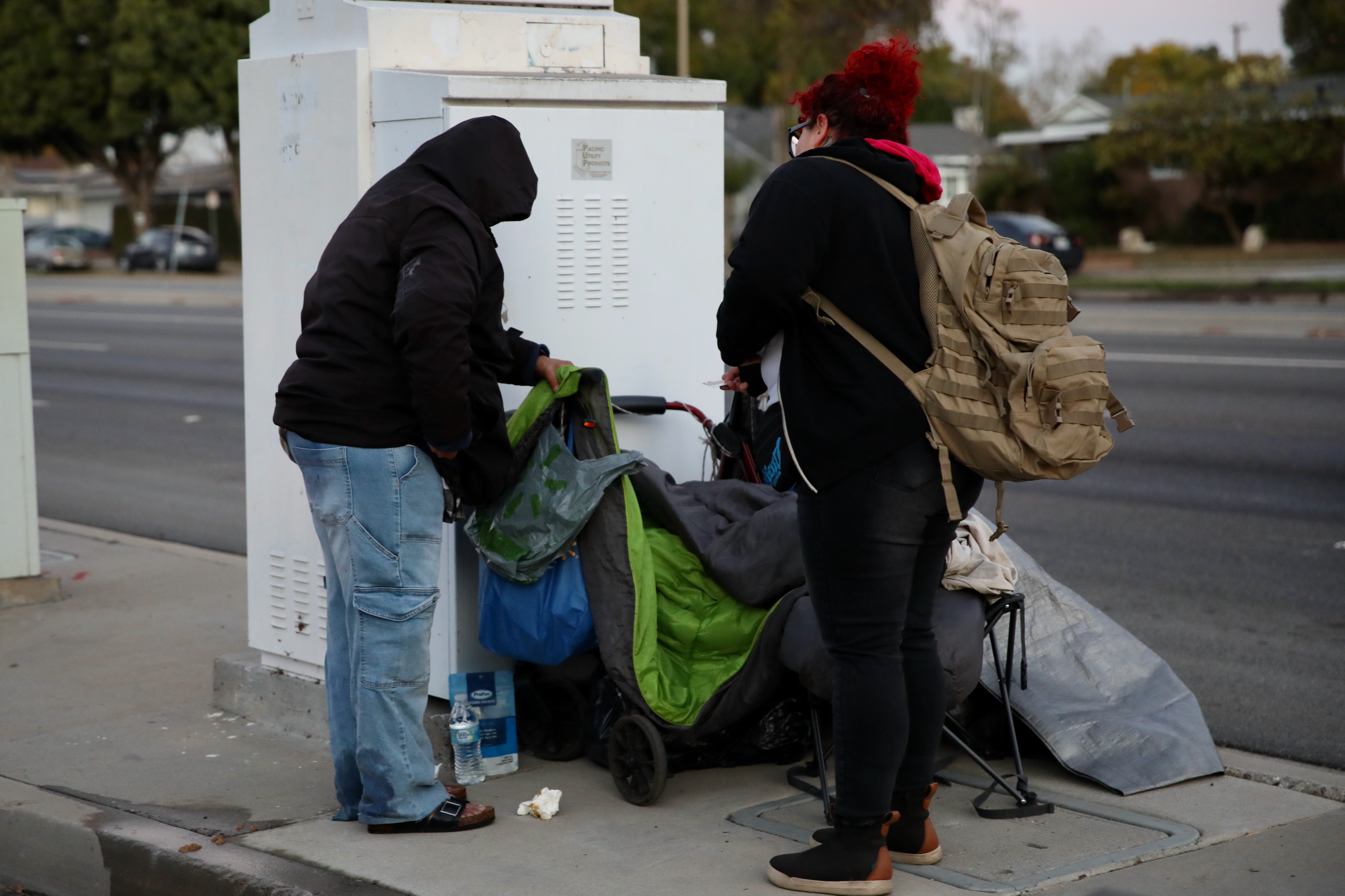 Volunteer Melanie Martins approaches a woman living on a street...