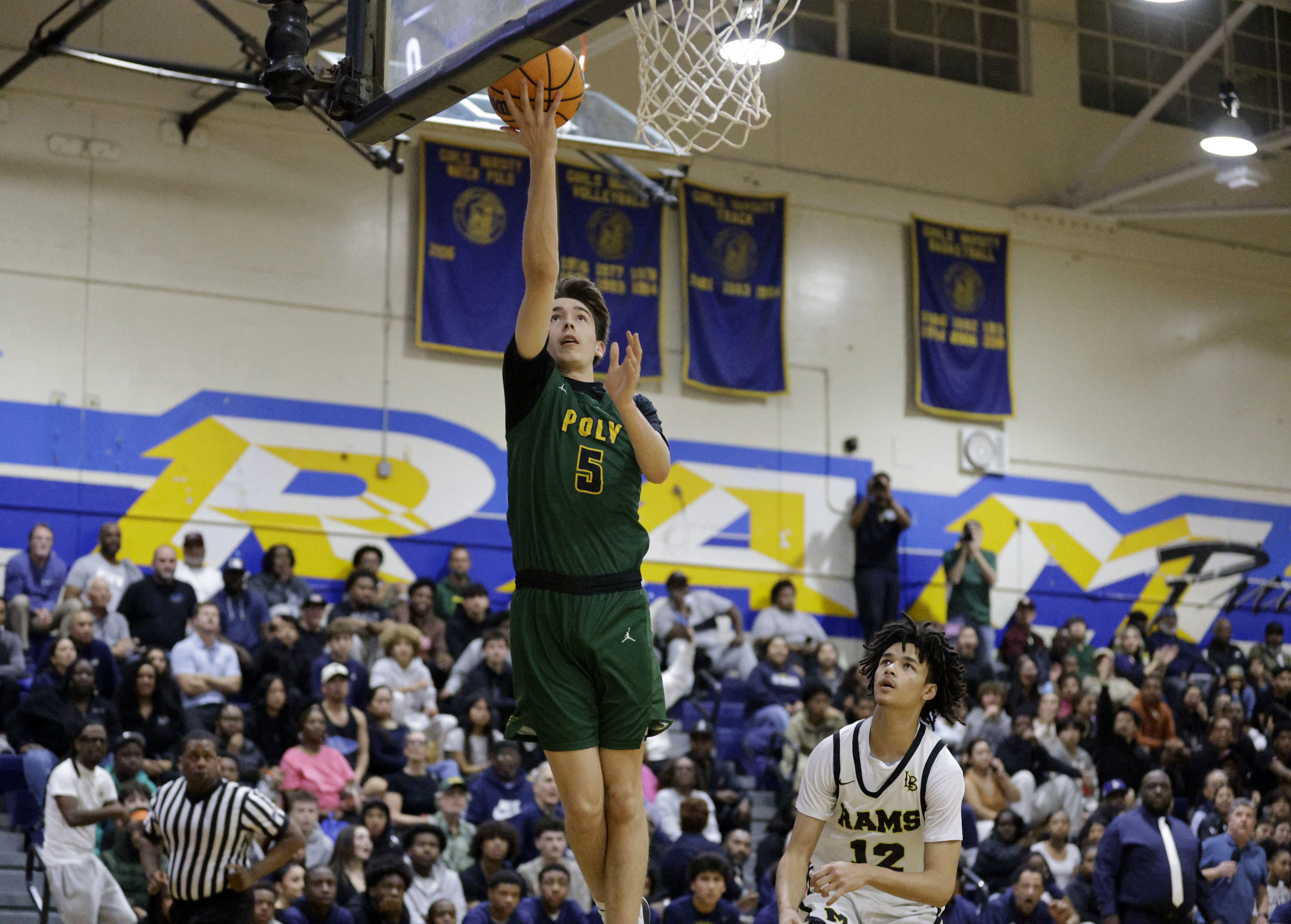 Long Beach Poly’s Julian Calderone (5) shoots for two as...