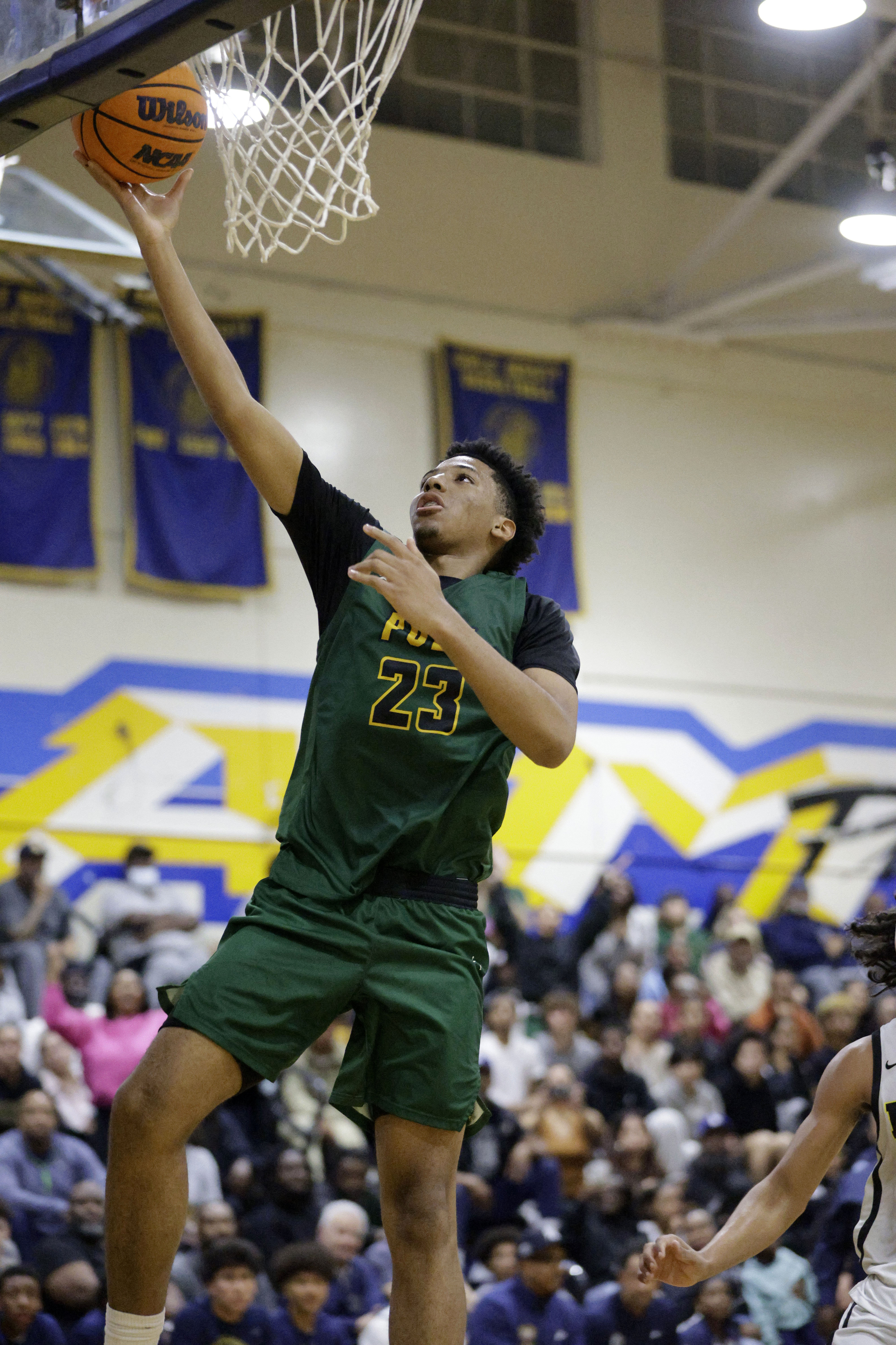 Long Beach Poly’s Isaac Hagens (23) goes up for two...