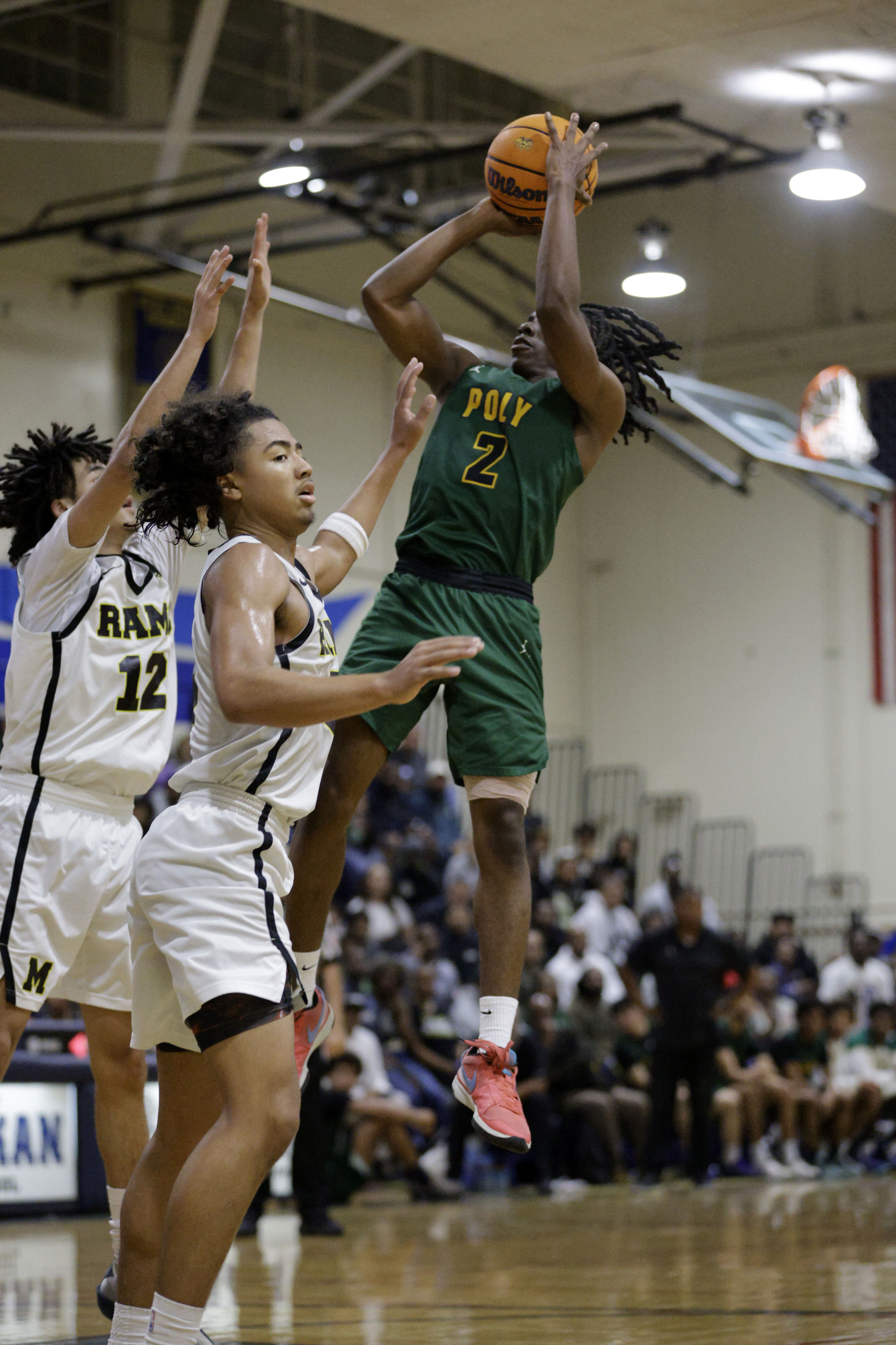Millikan’s Jeremiah Hunt (12) and Joseph Wicker (3) try to...