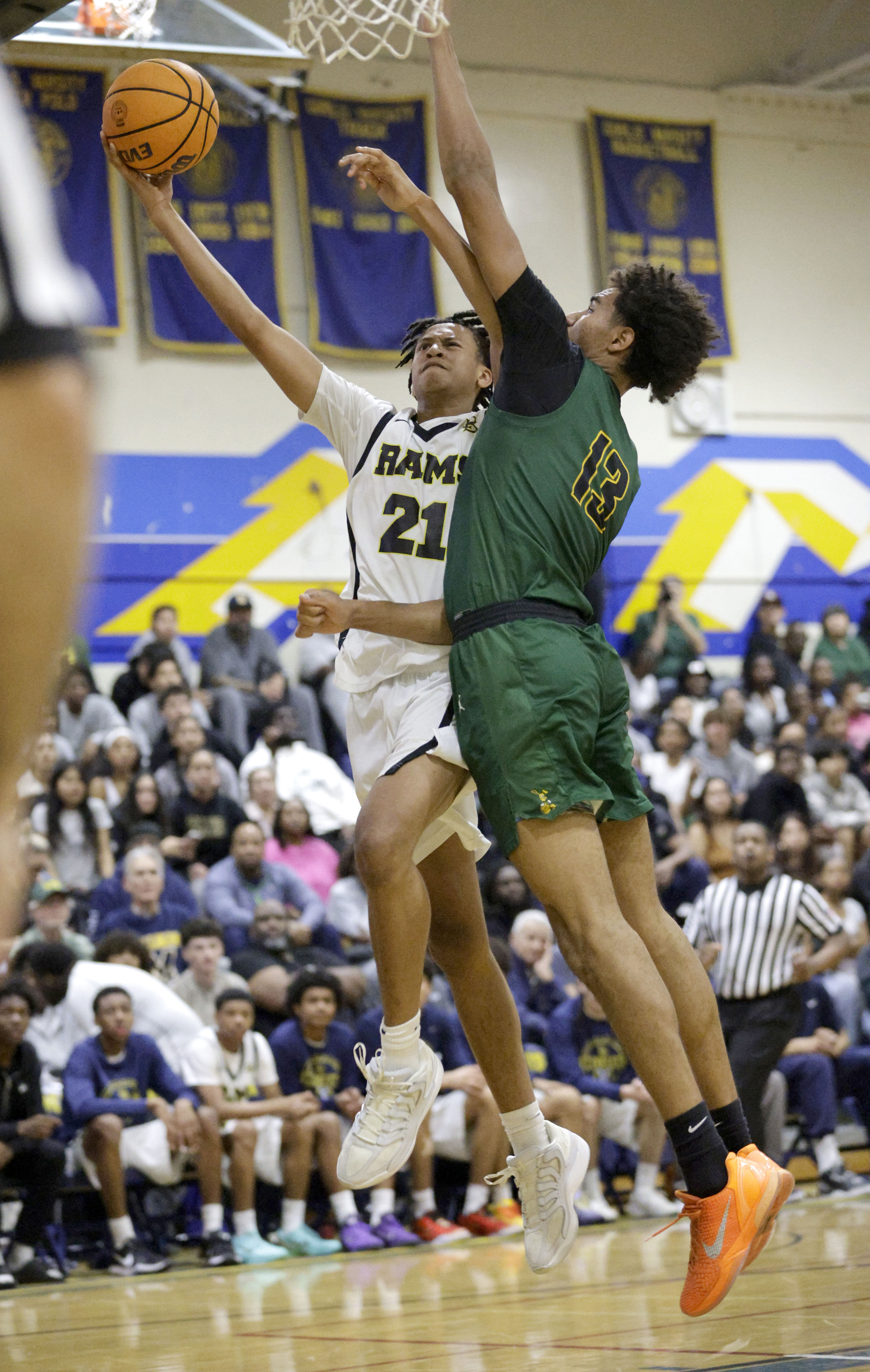 Millikans’ Christian Parron (21) tries to shoot around Long Beach...