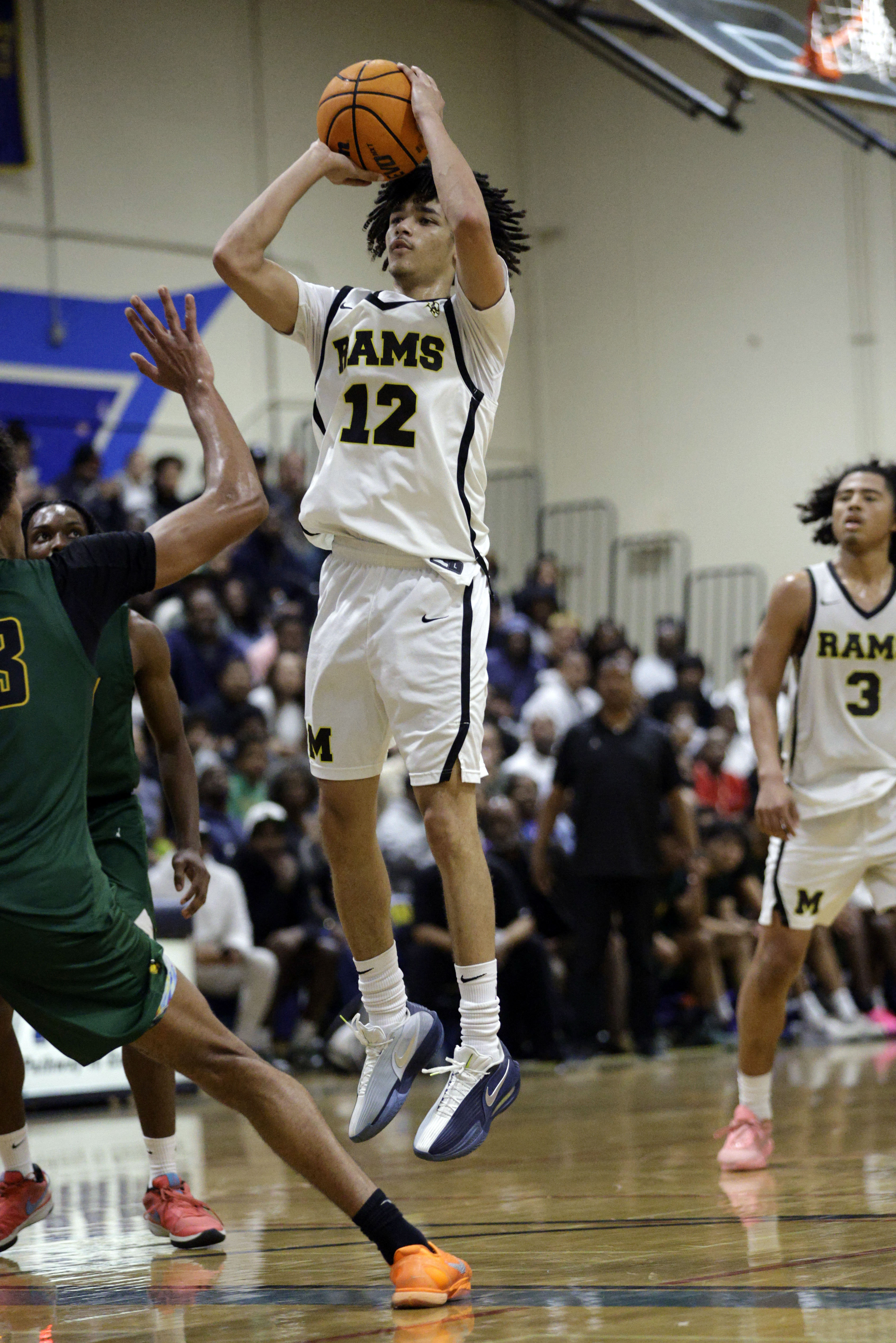 Millikan’s Jeremiah Hunt (12) shoots for two as the Rams...