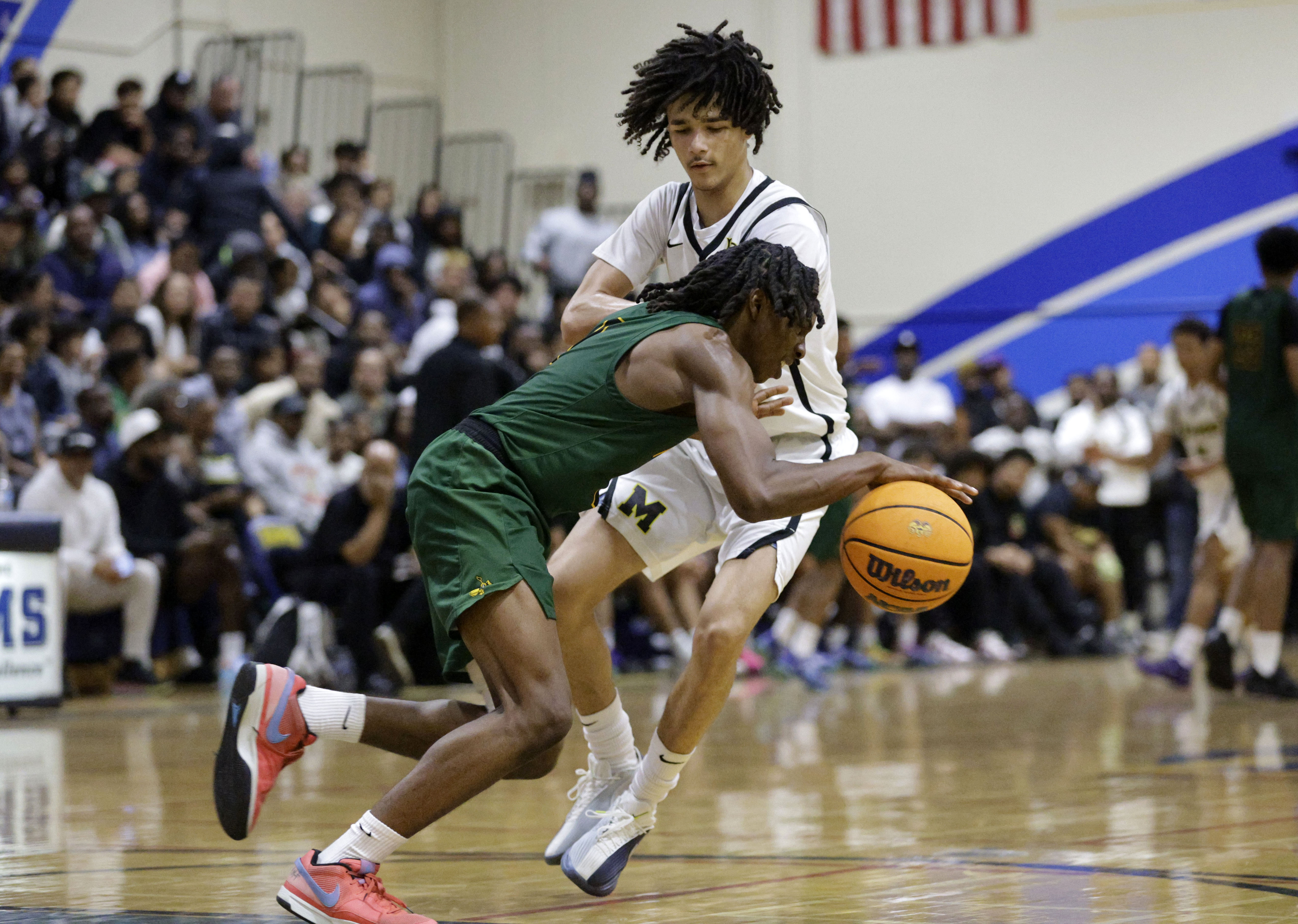 Long Beach Poly’s Nana Ofoegbu (2) tries to get around...