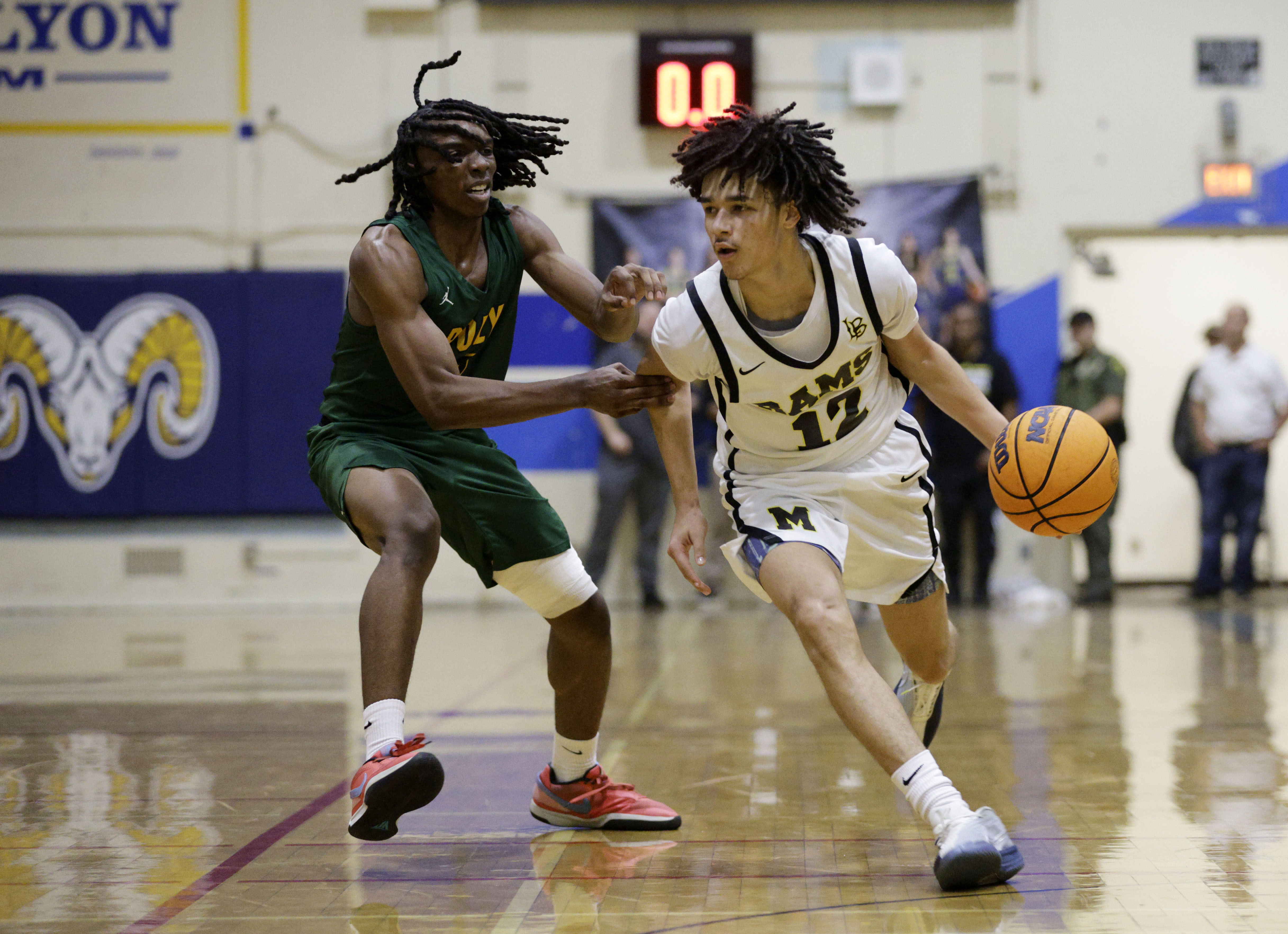 Millikan’s Jeremiah Hunt (12) looks to get past Long Beach...