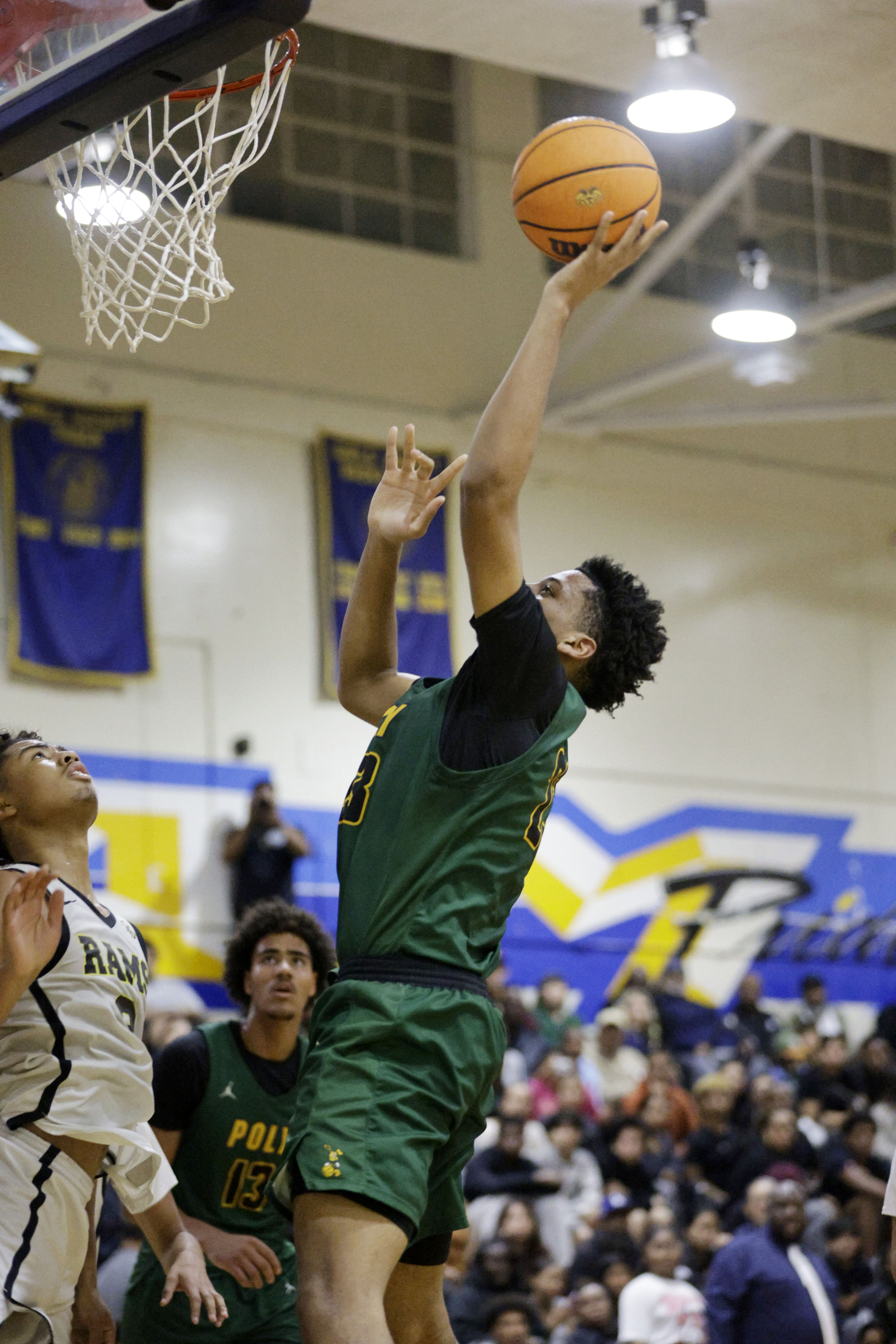 Long Beach Poly’s Isaac Hagens (23) shoots for two as...