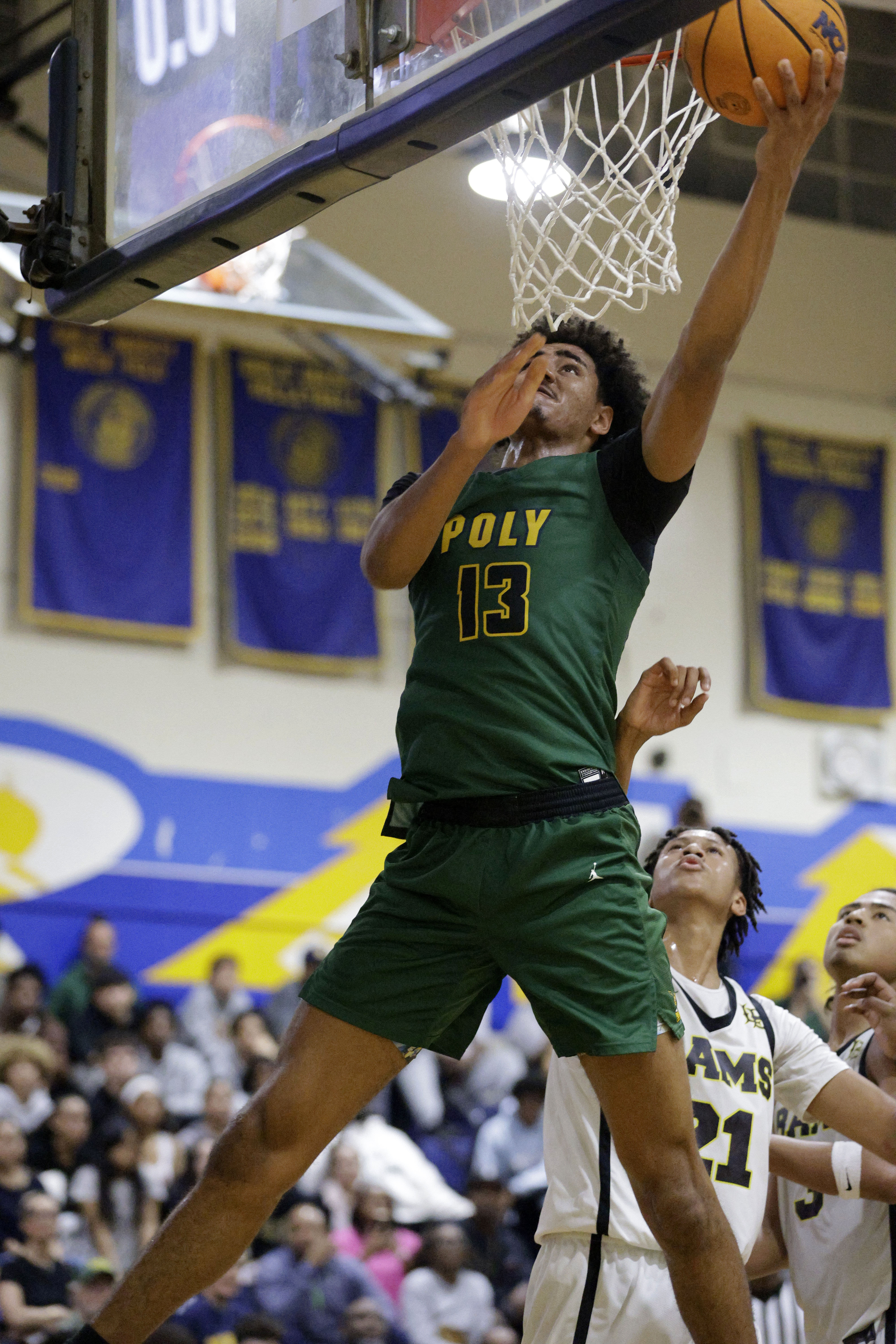 Long Beach Poly’s Jonas Oware (13) shoots for two as...