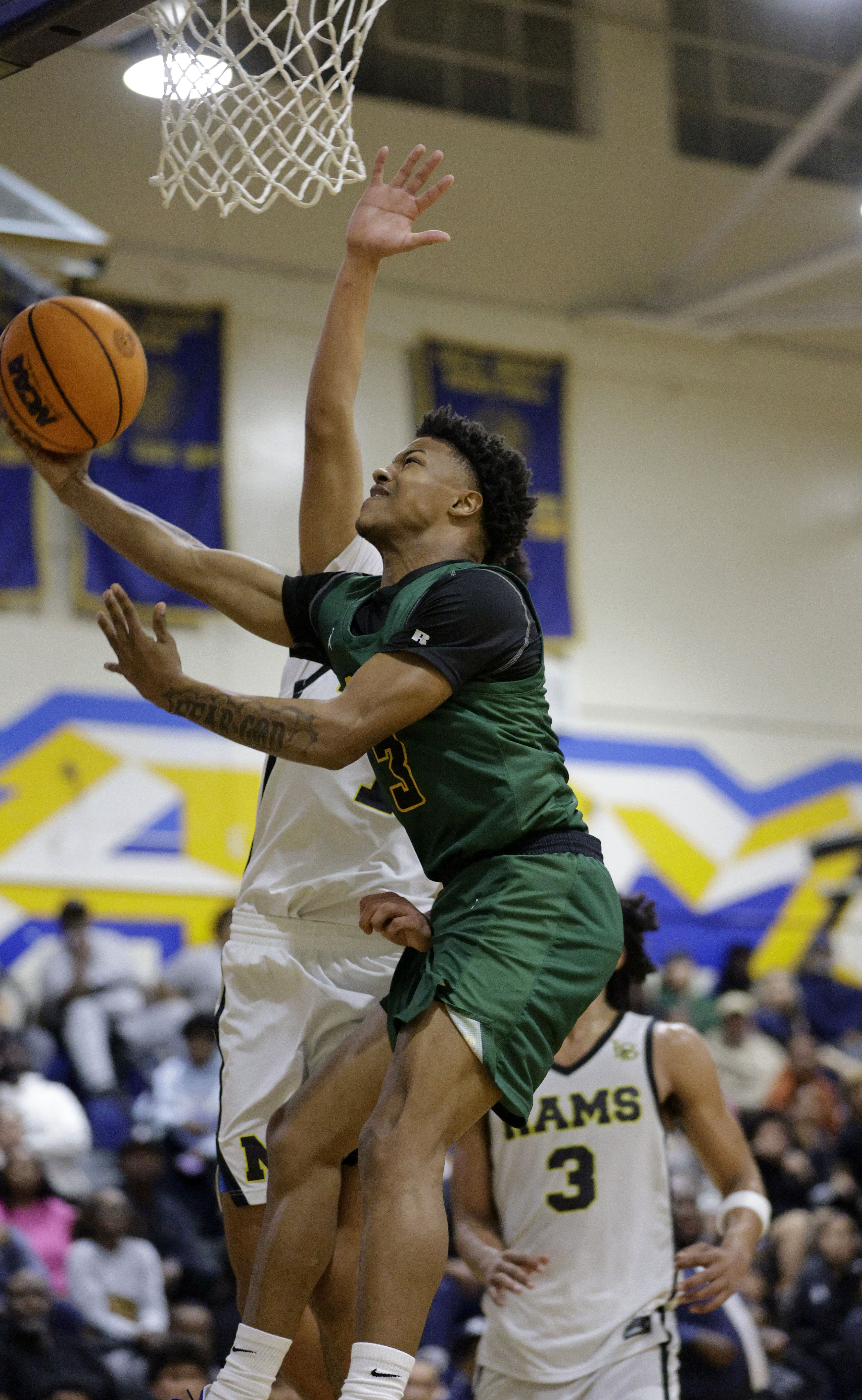 Long Beach Poly’s Kamarie Smith (3) shoots for two as...