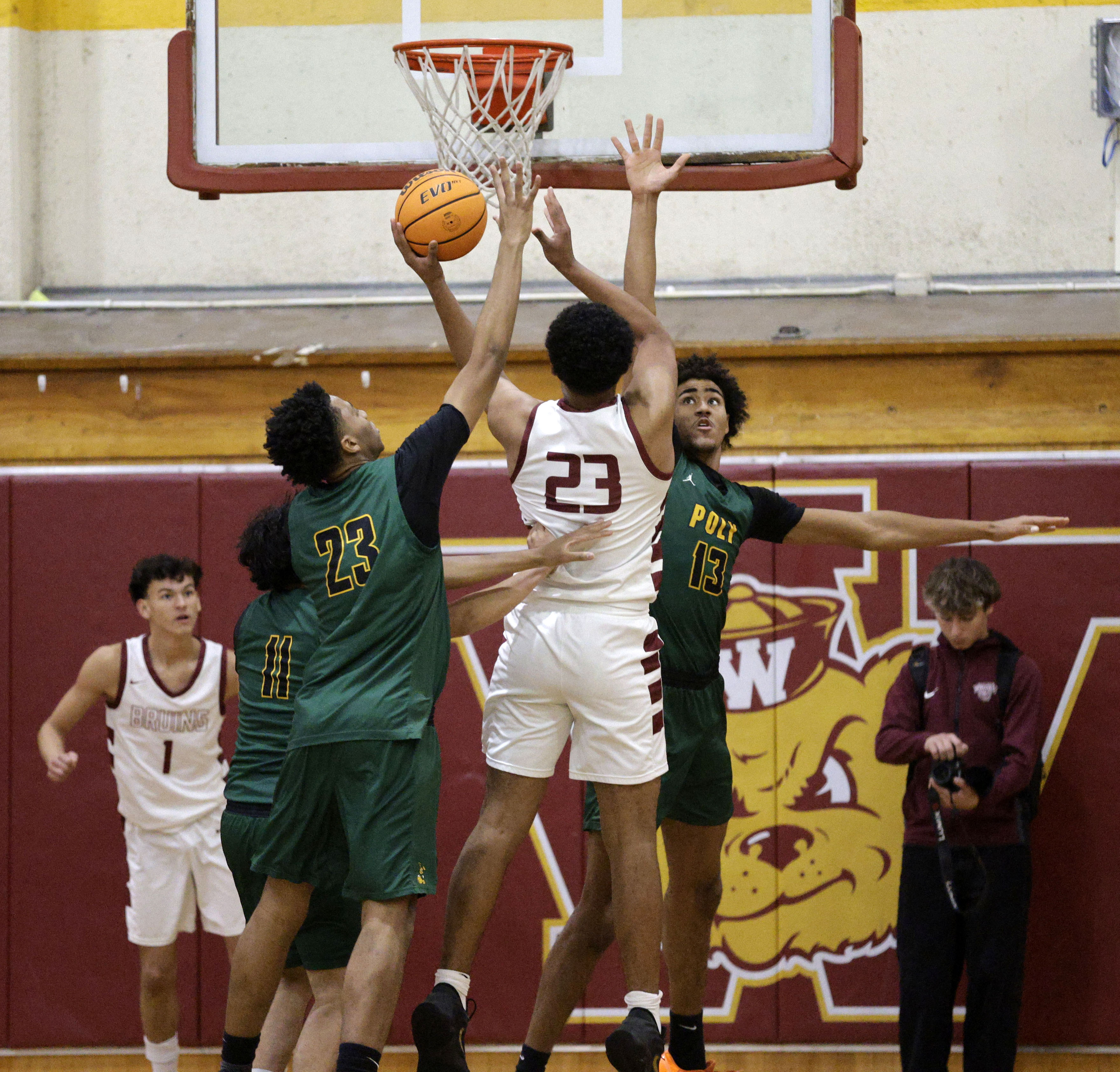 Long Beach Polys Isaac Hagens (23) and Jonas Oware (13)...