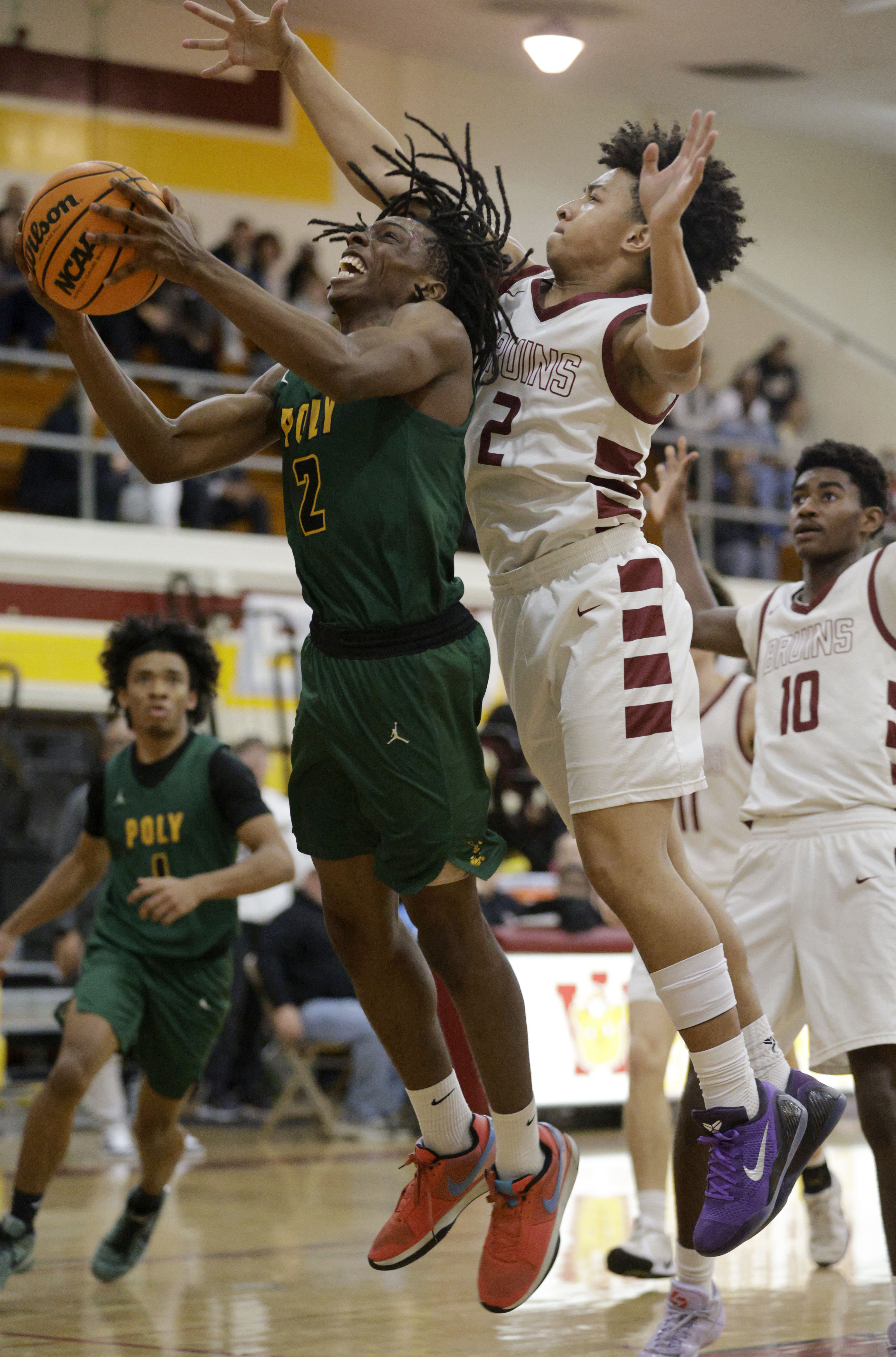 Wilsons Jaysen Burkley (2) tries to block Long Beach Polys...