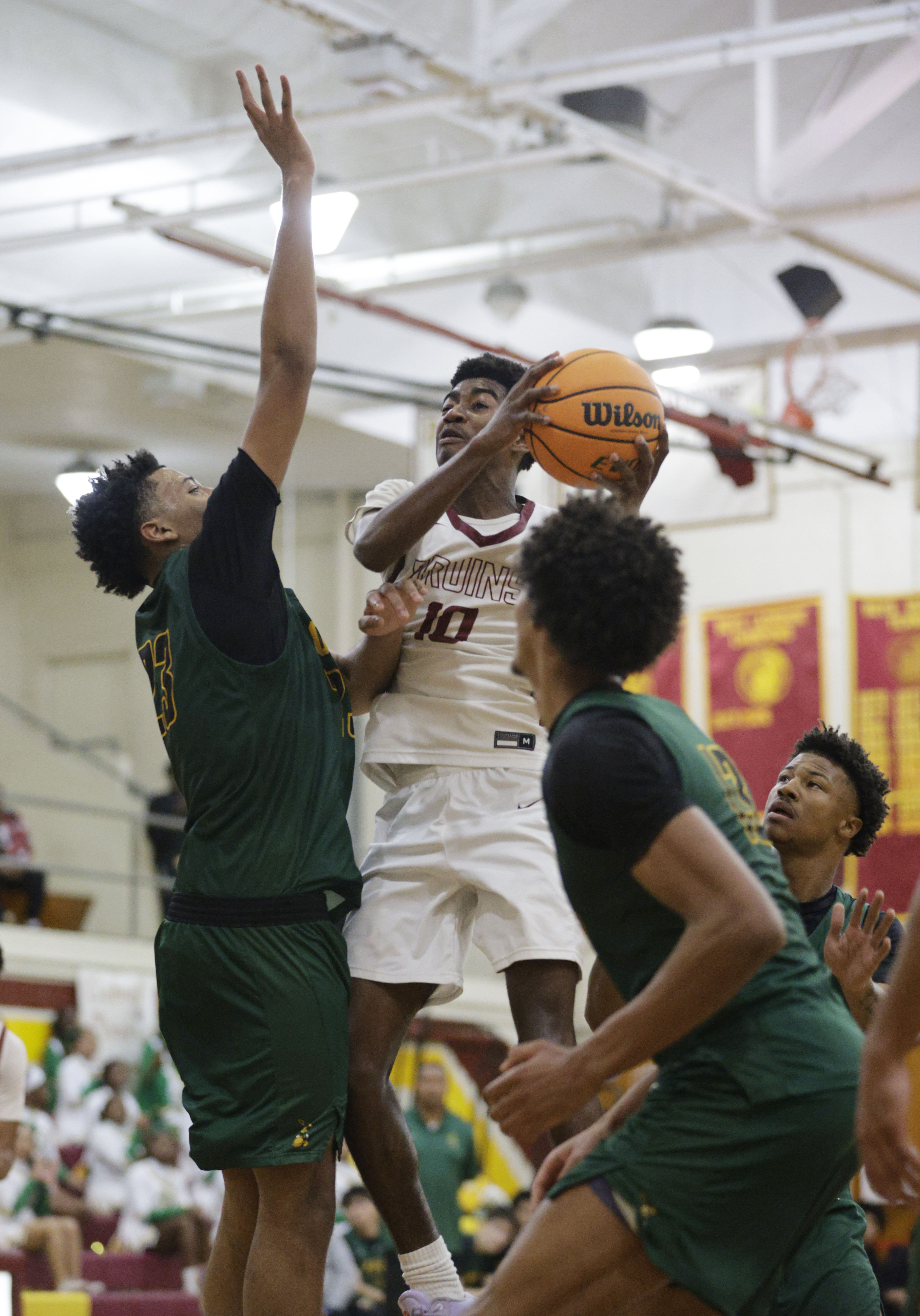 Wilsons Nehemiah Parris (10) tries to shoot around Long Beach...