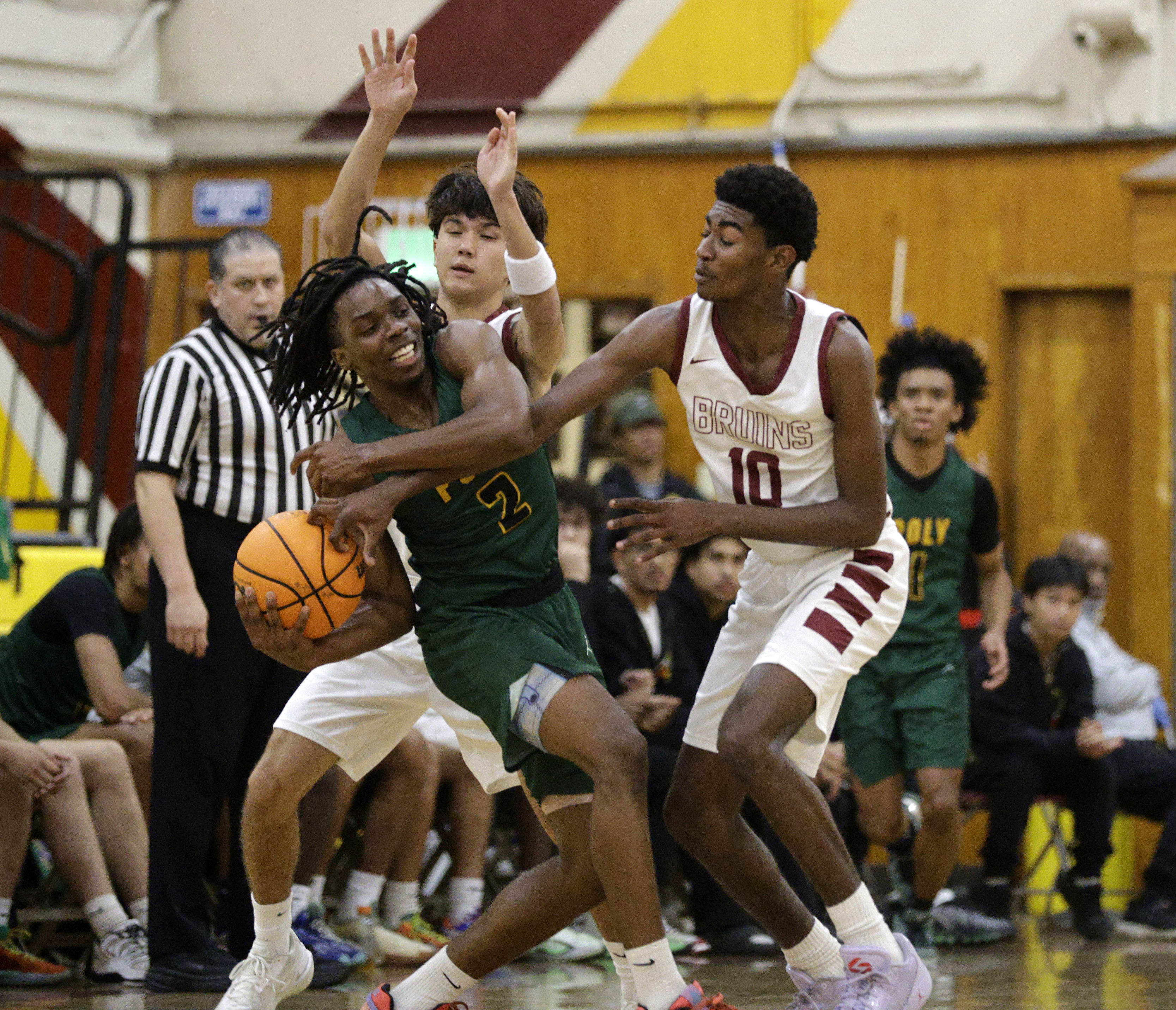 Wilsons Sean Deledonne (12) and Nehemiah Parris (10) try to...