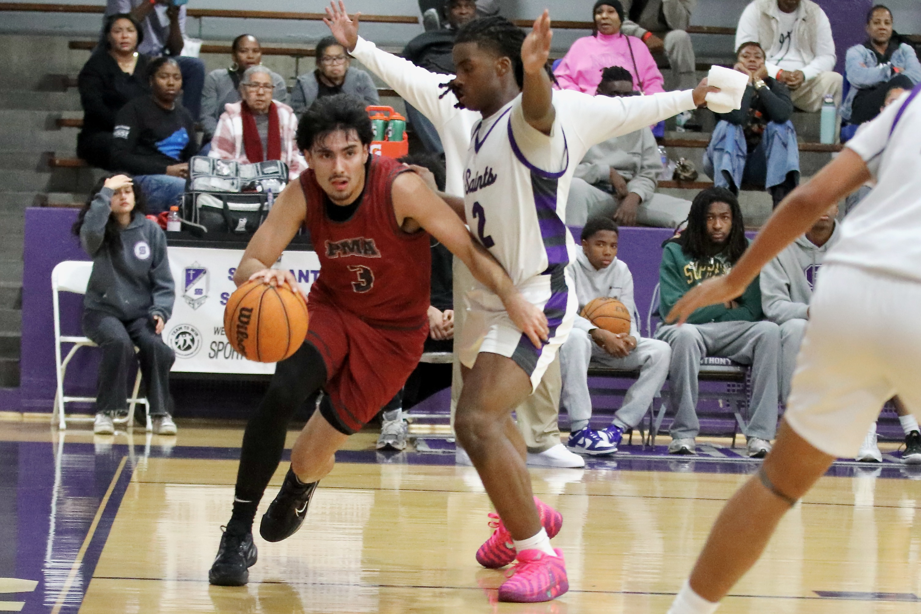 St. Pius X-St. Matthias guard Dominic Gallardo drives along the...