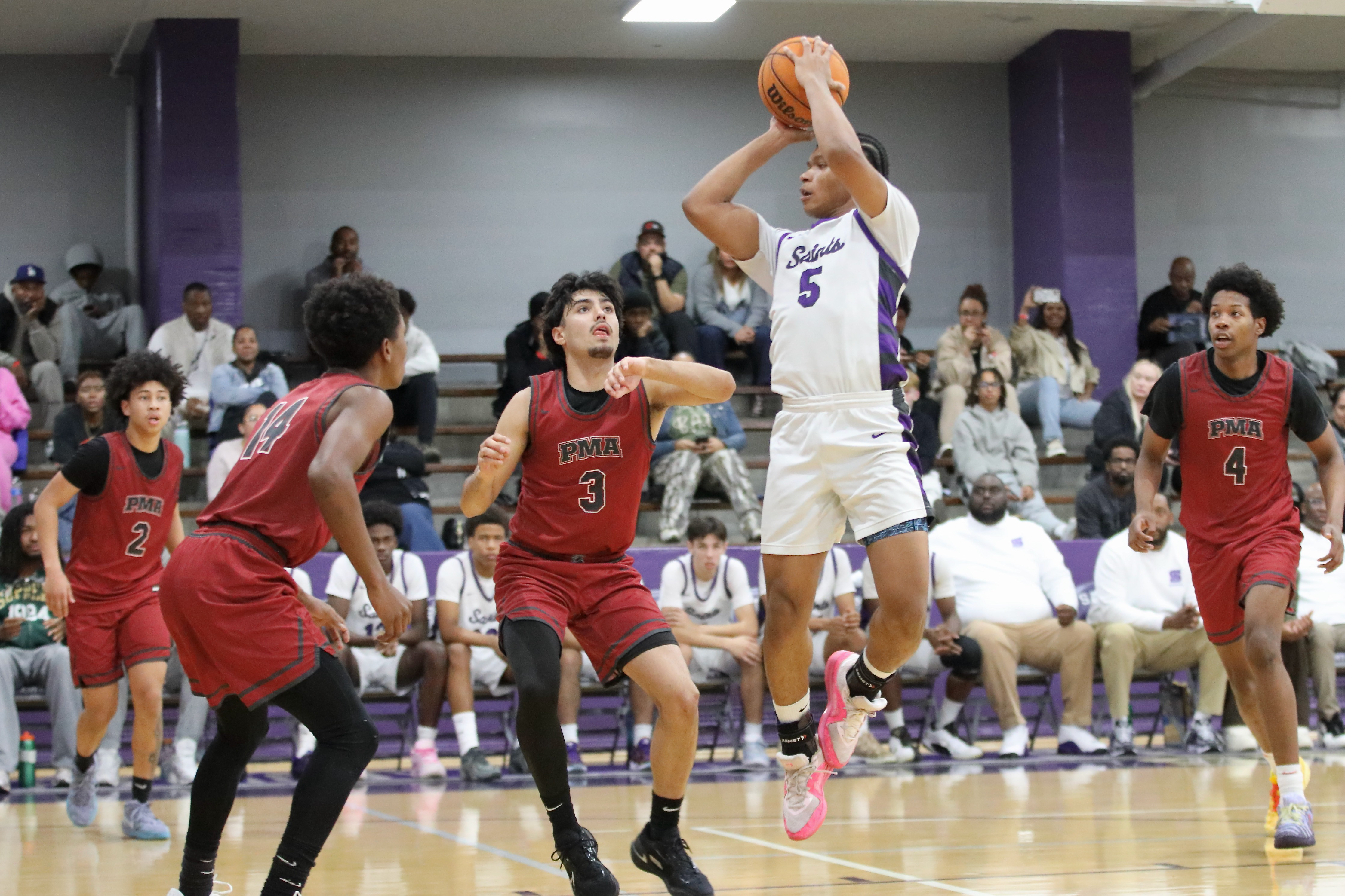 St. Anthonyâs Marinio Elissaint (#5) looks for an open man...