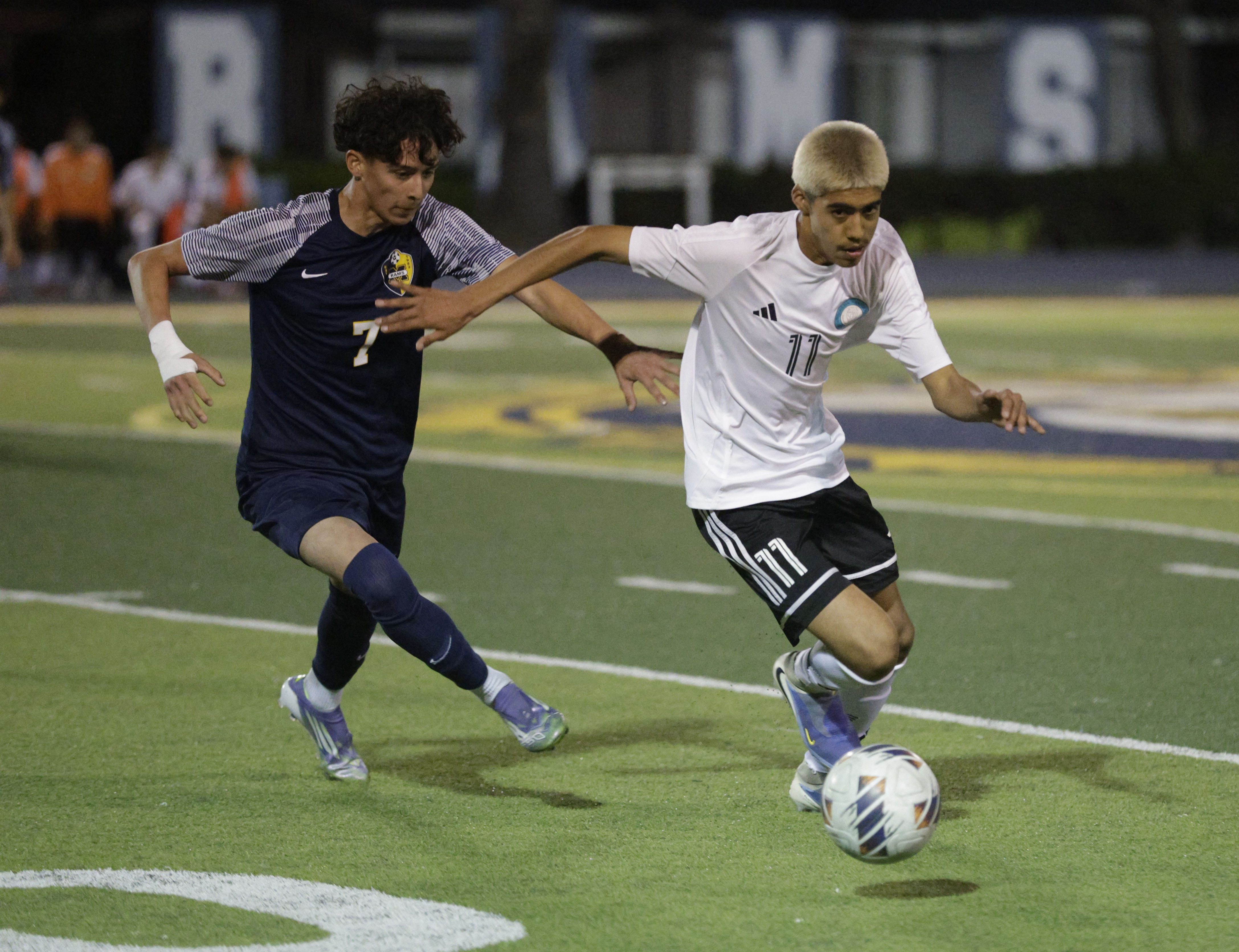 Long Beach Poly’s Benito Quezada (11) tries to keep the...