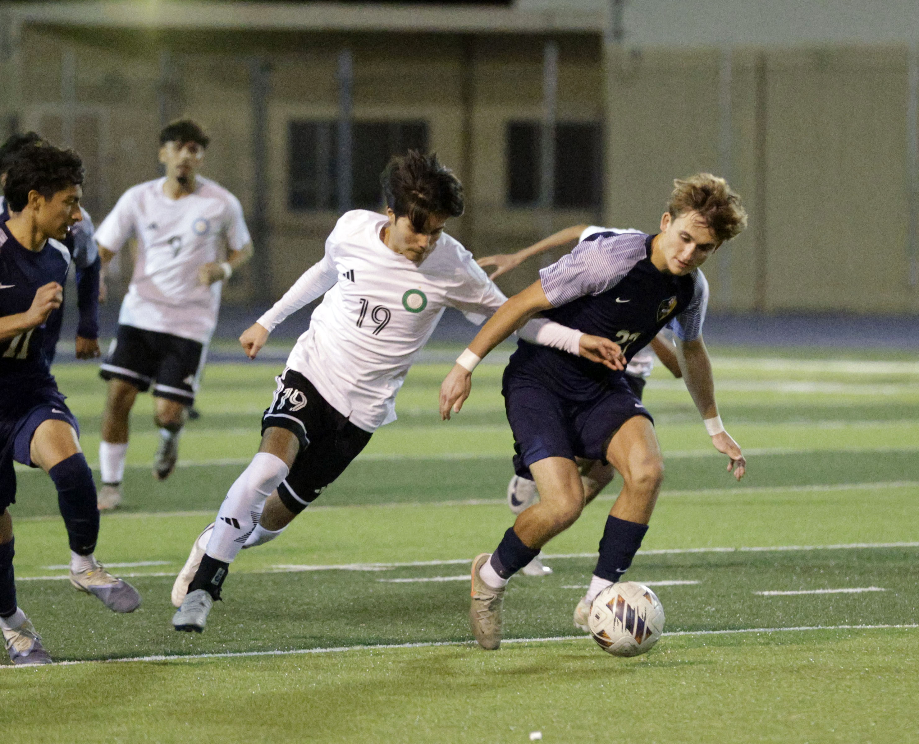 Long Beach Poly’s Marcel Markaryan (19) and Millikan’s Grant Johnson...