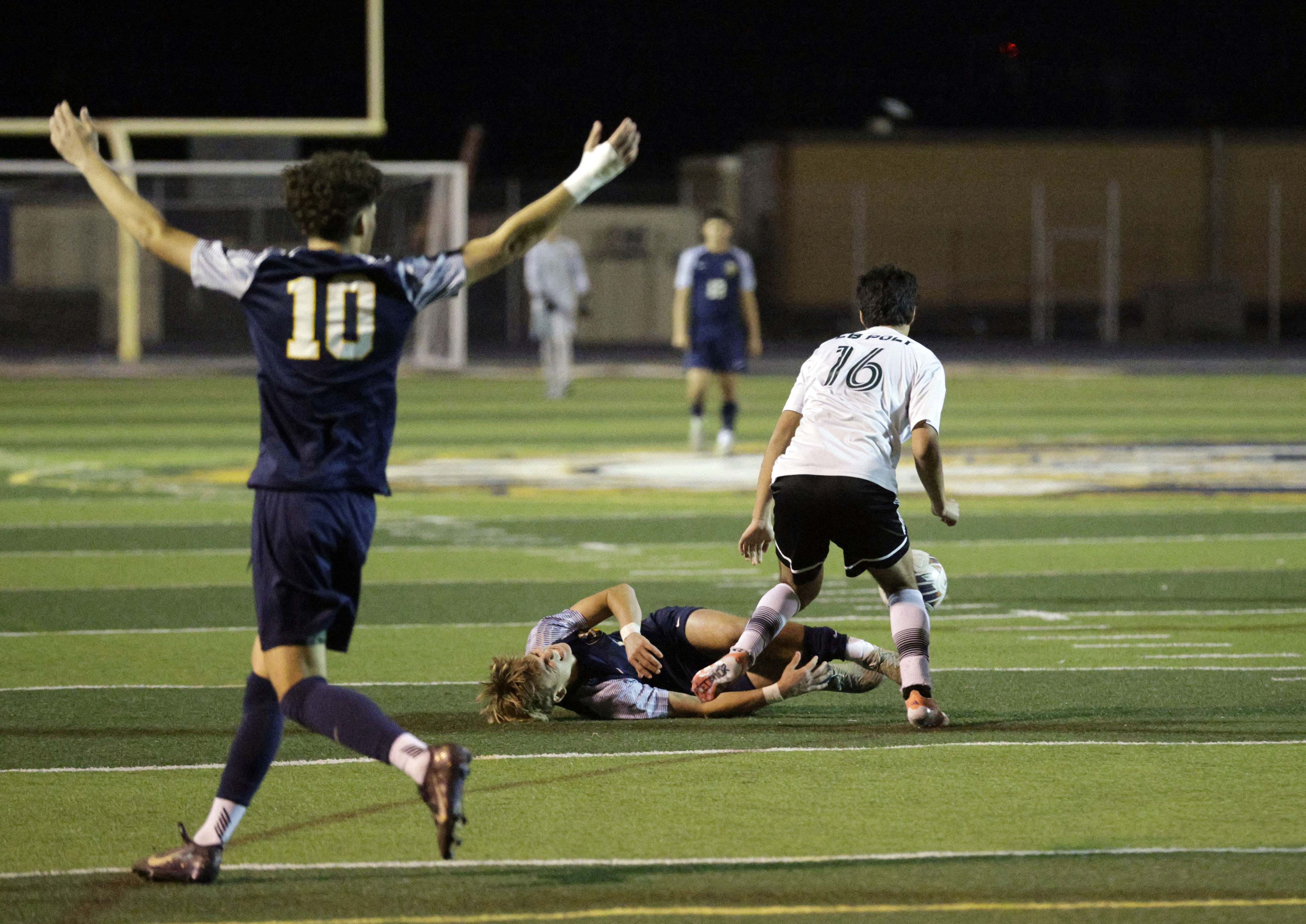 Millikan’s Bernardo Torres (10) wants a foul called as teammate...