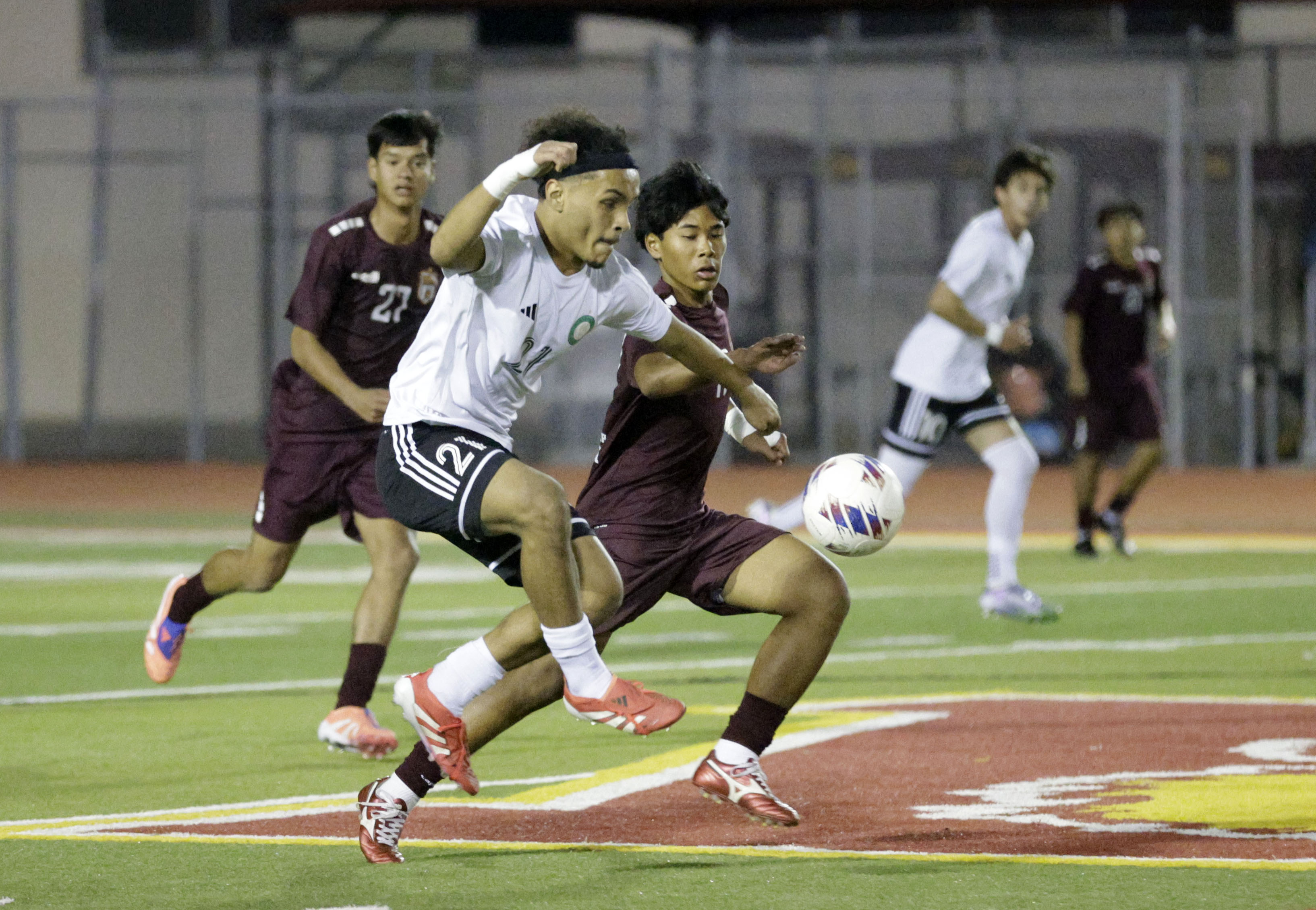 Long Beach Poly’s Roger Juarez (21) looks to keep the...