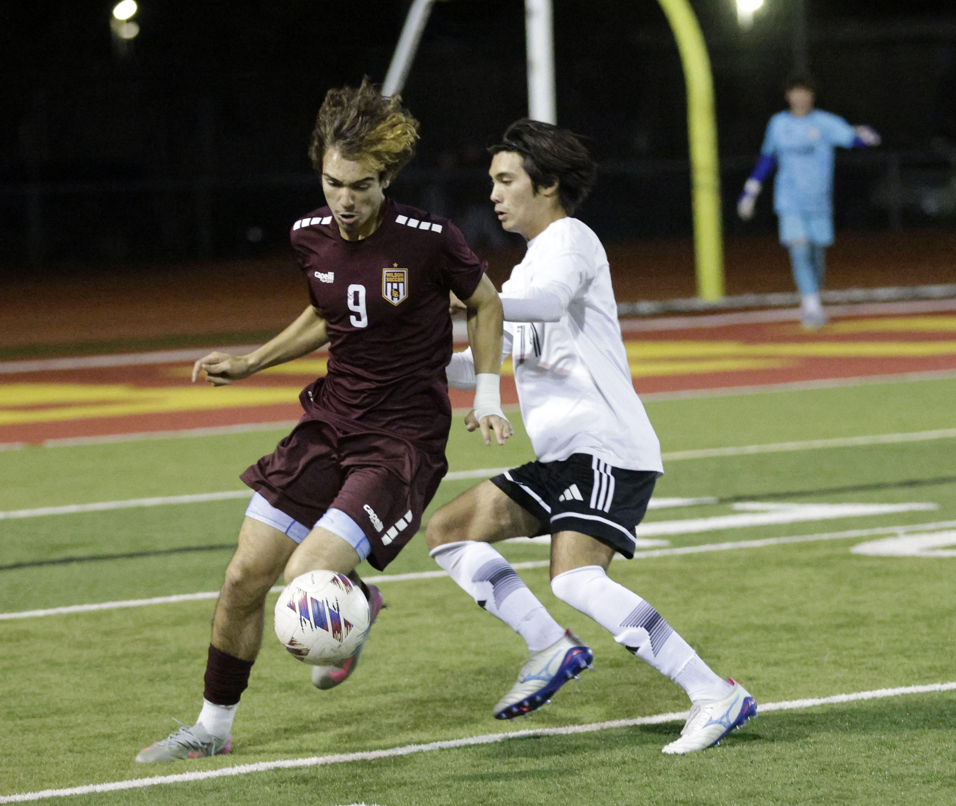 Wilson’s Casey Pettyjohn (9) keeps the ball from Long Beach...