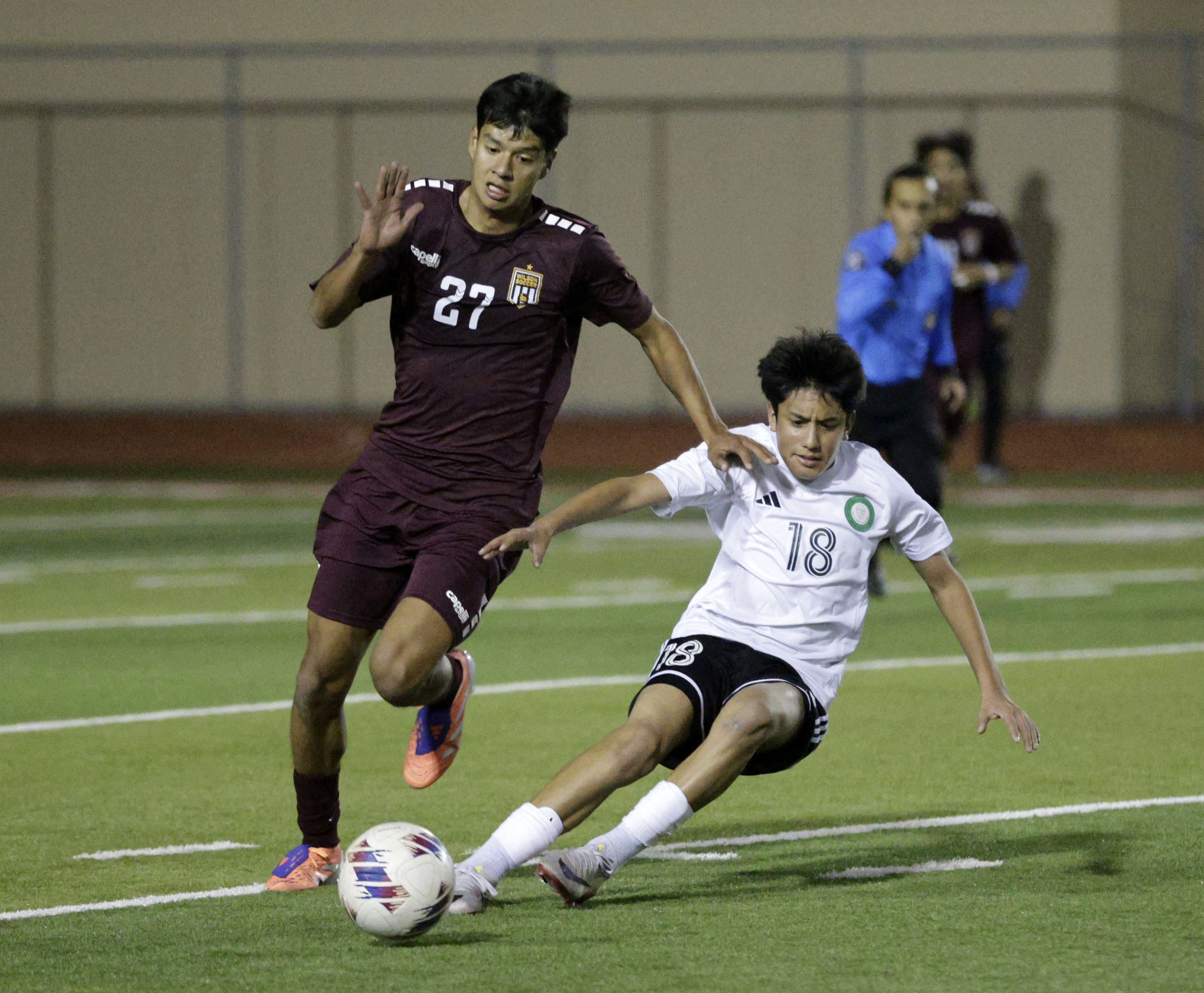 Wilson’s Diego Castro (27) battle Long Beach Poly’s Carlos Casillas...
