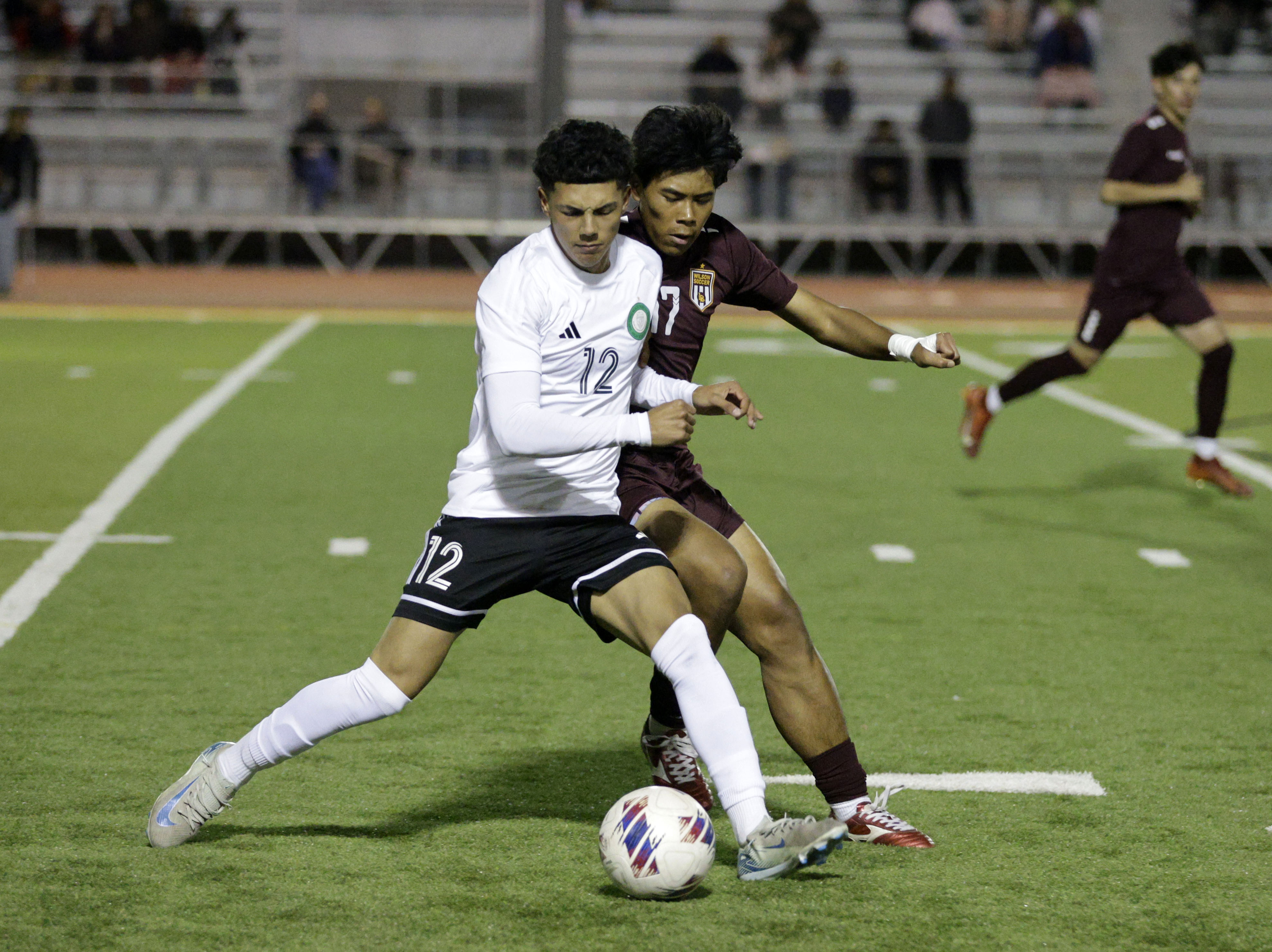 Long Beach Poly’s Joseph Lemus (12) keeps the ball from...
