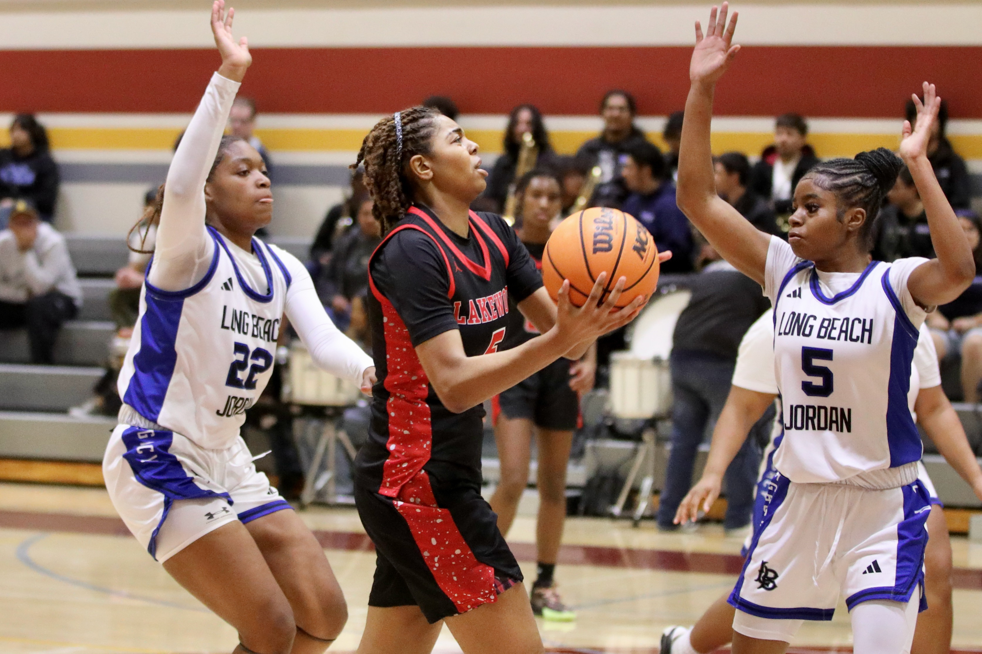 Lakewood sophomore Laylah Patterson splits the Jordan defense as she...