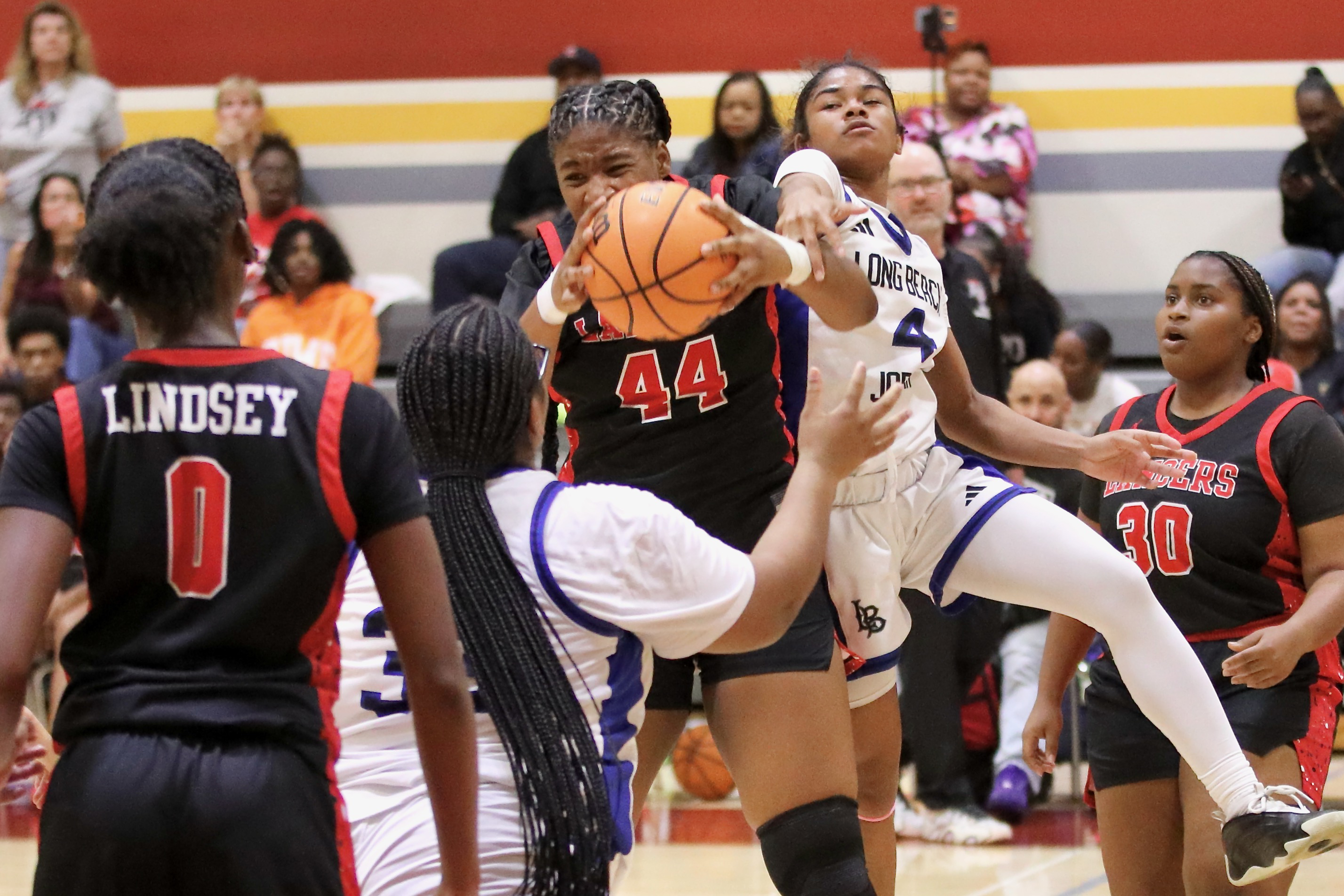 Lakewood center Kasey-Rian Henson (44) pulls down a rebound in...